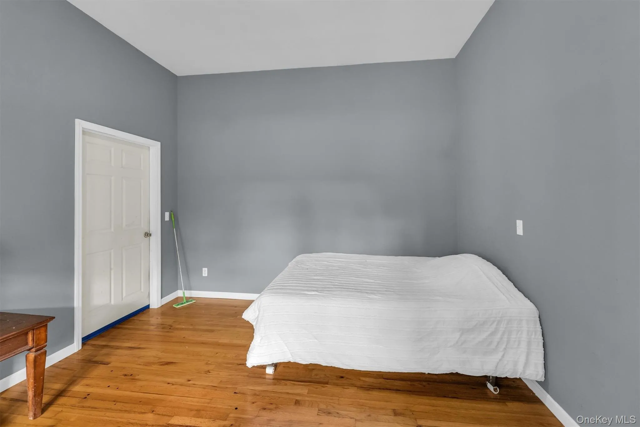 Bedroom with baseboards and wood-type flooring Bedroom with baseboards and wood-type flooring