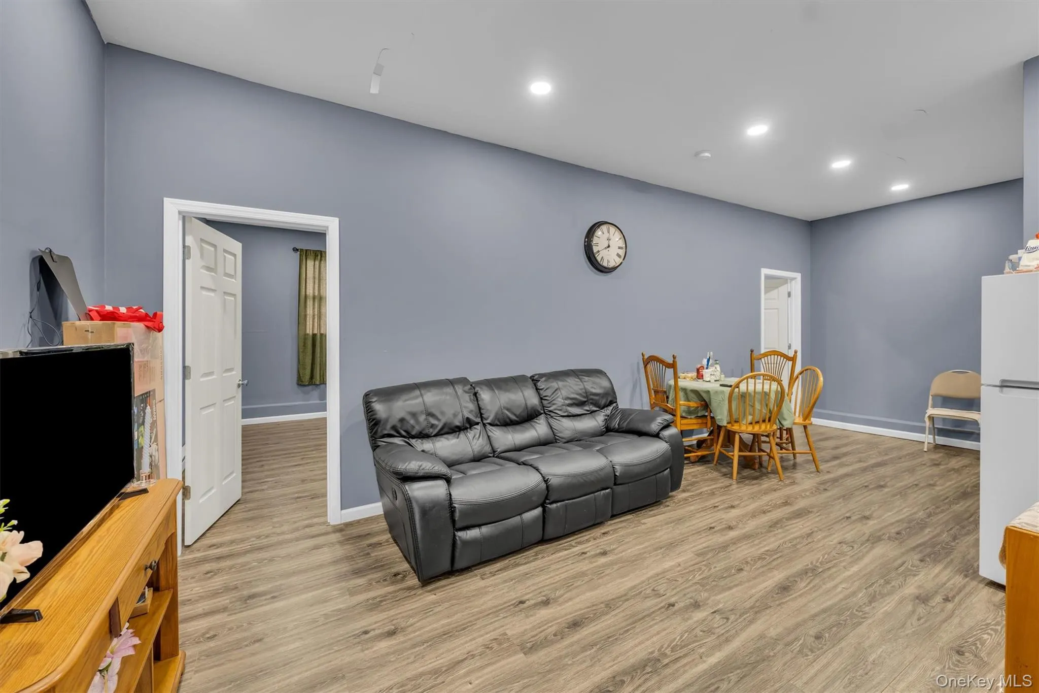 Living room with light wood-style flooring and recessed lighting Living room with light wood-style flooring and recessed lighting