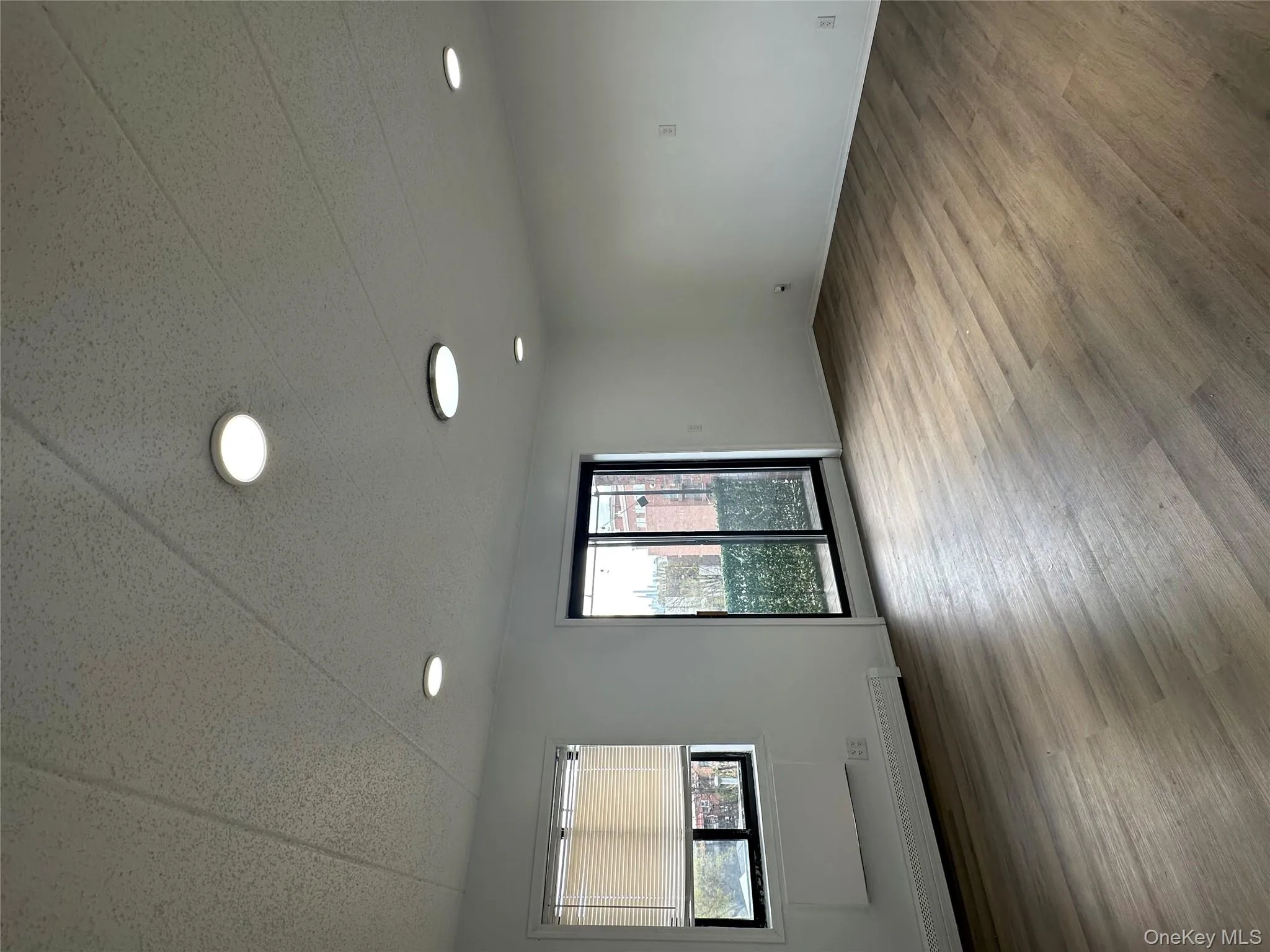 Living area, wood finished floors, and baseboards Living area, wood finished floors, and baseboards