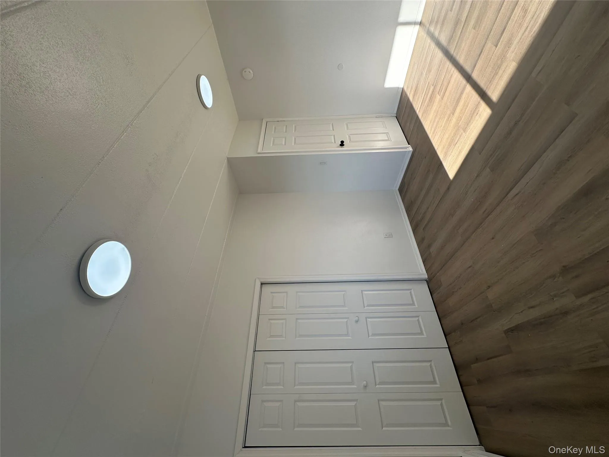 Primary bedroom with baseboards, wood finished floors, a textured ceiling, and a closet Primary bedroom with baseboards, wood finished floors, a textured ceiling, and a closet