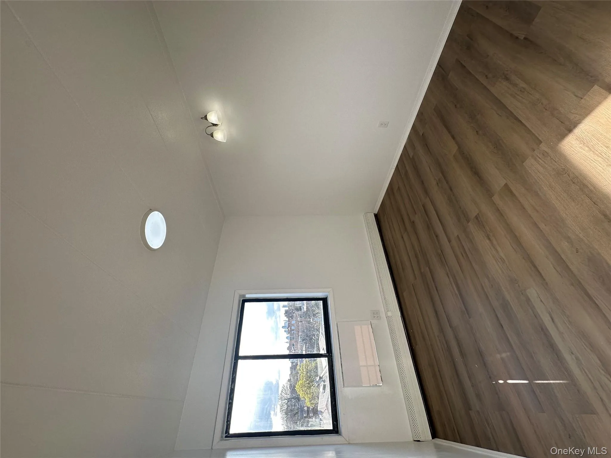 Bedroom with a baseboard radiator, and dark wood-style flooring Bedroom with a baseboard radiator, and dark wood-style flooring