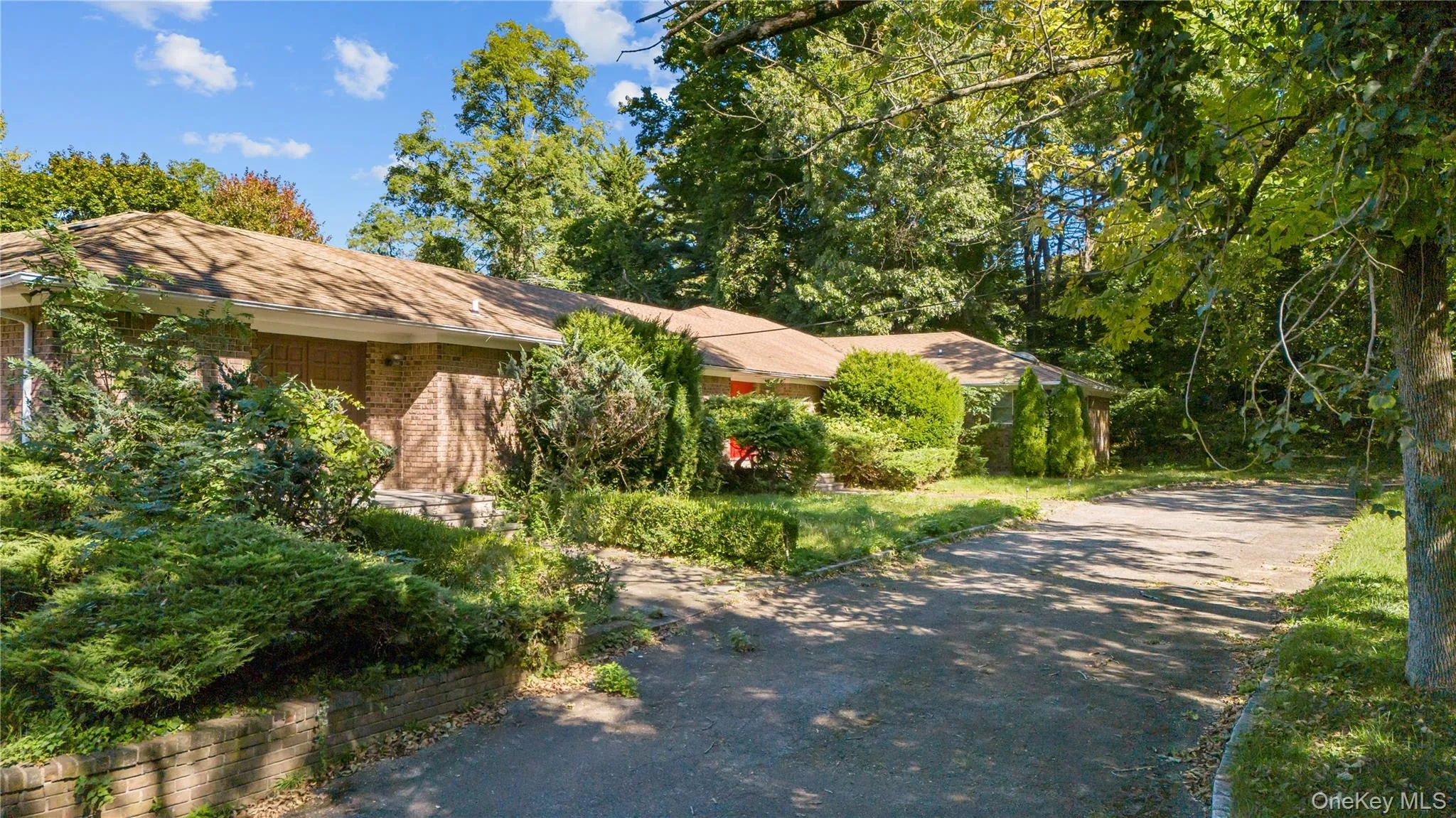 View of front of home with driveway and brick. View of front of home with driveway and brick.