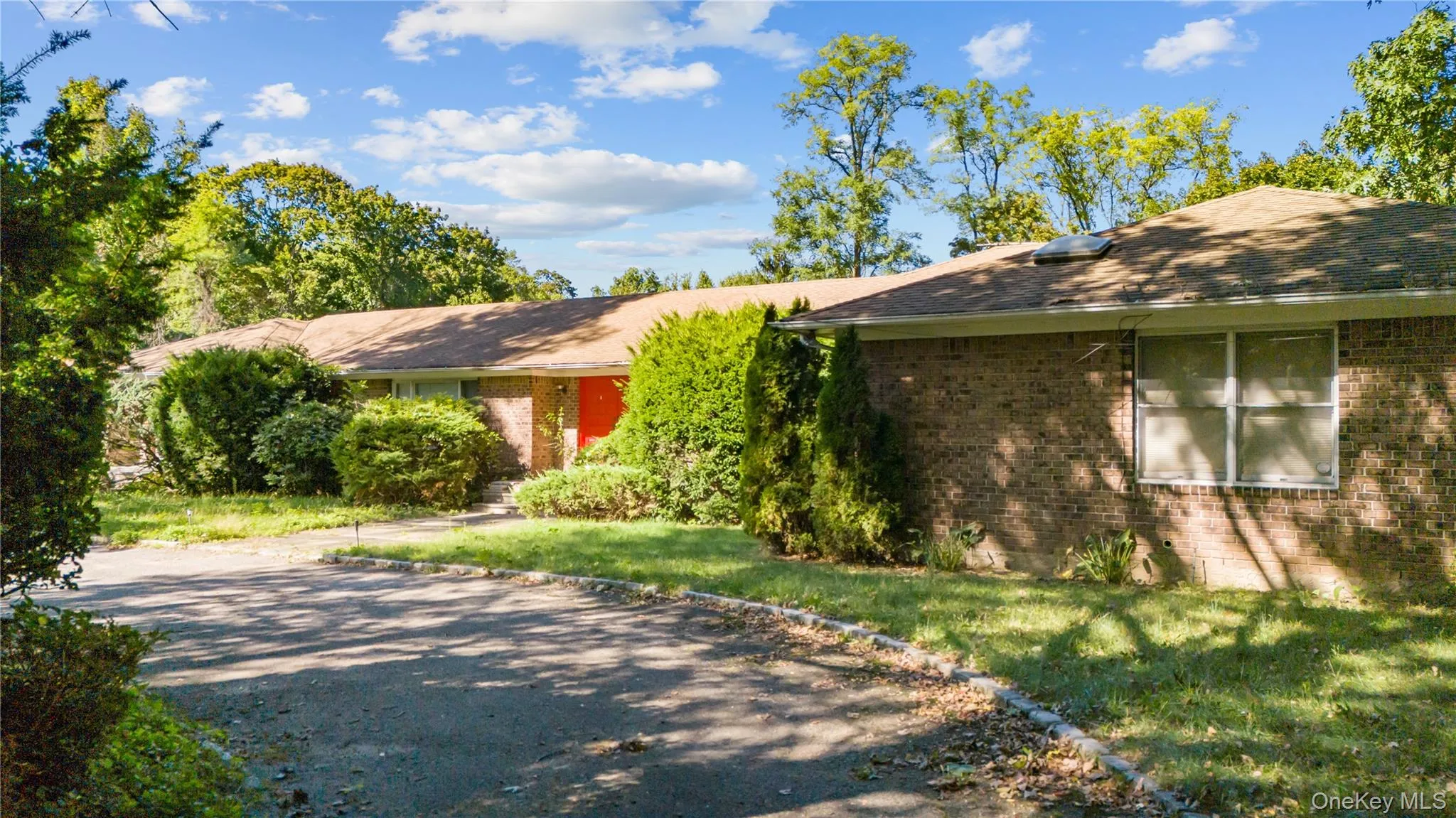 Single story home with brick, driveway, and a front yard Single story home with brick, driveway, and a front yard