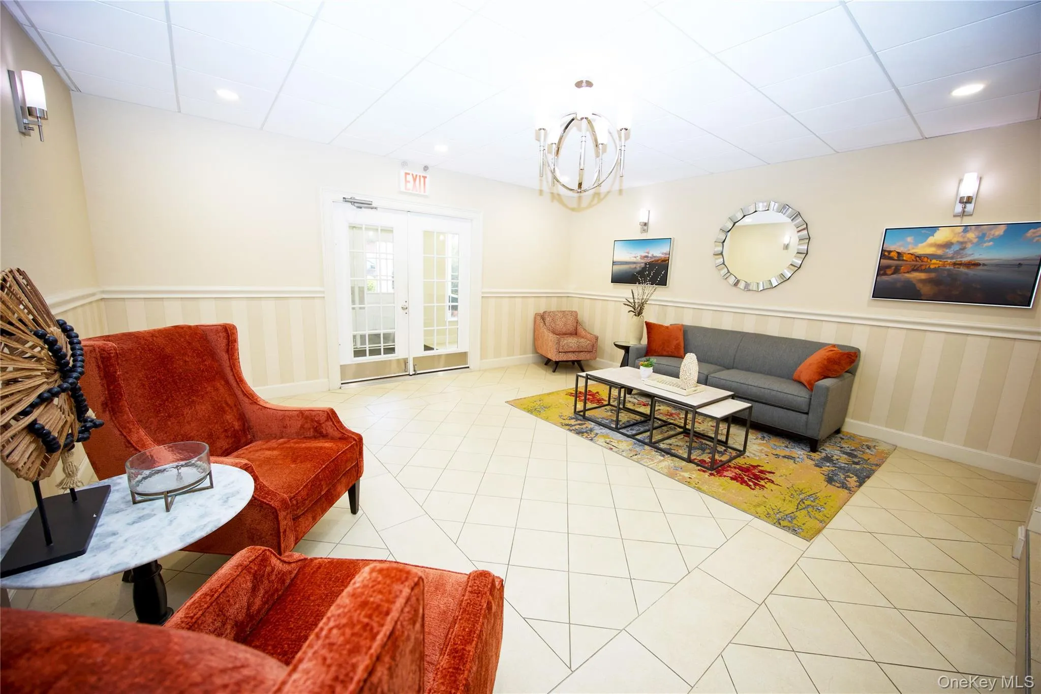 Living area featuring a wainscoted wall, light tile patterned floors, recessed lighting, a paneled ceiling, and french doors Living area featuring a wainscoted wall, light tile patterned floors, recessed lighting, a paneled ceiling, and french doors