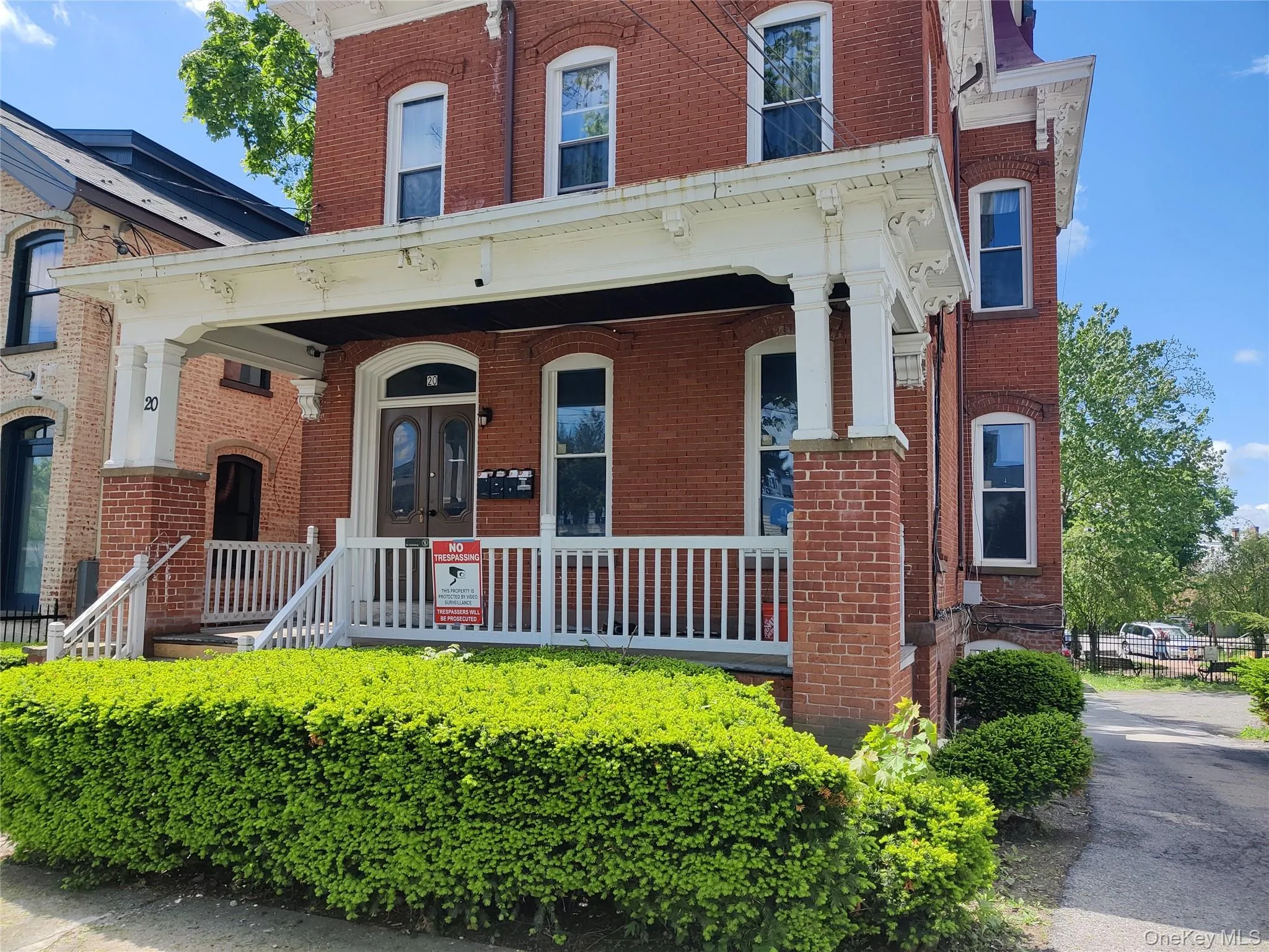 Italianate house with a porch and brick siding Italianate house with a porch and brick siding