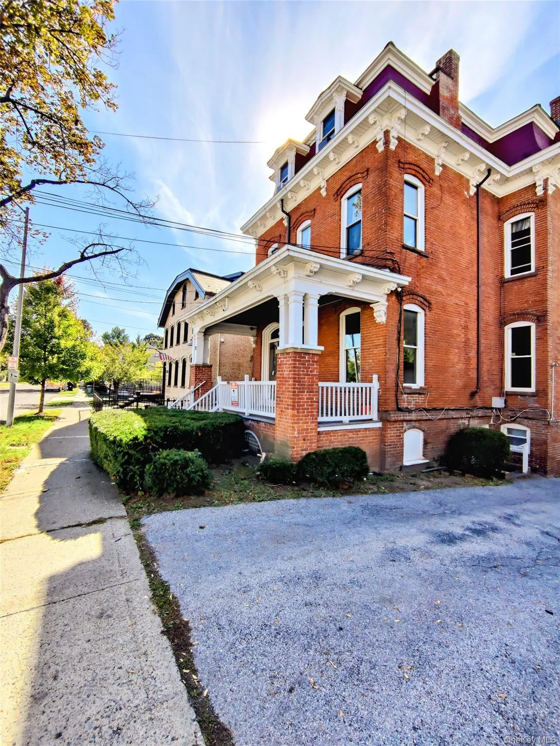 Italianate home with covered porch and brick siding Italianate home with covered porch and brick siding