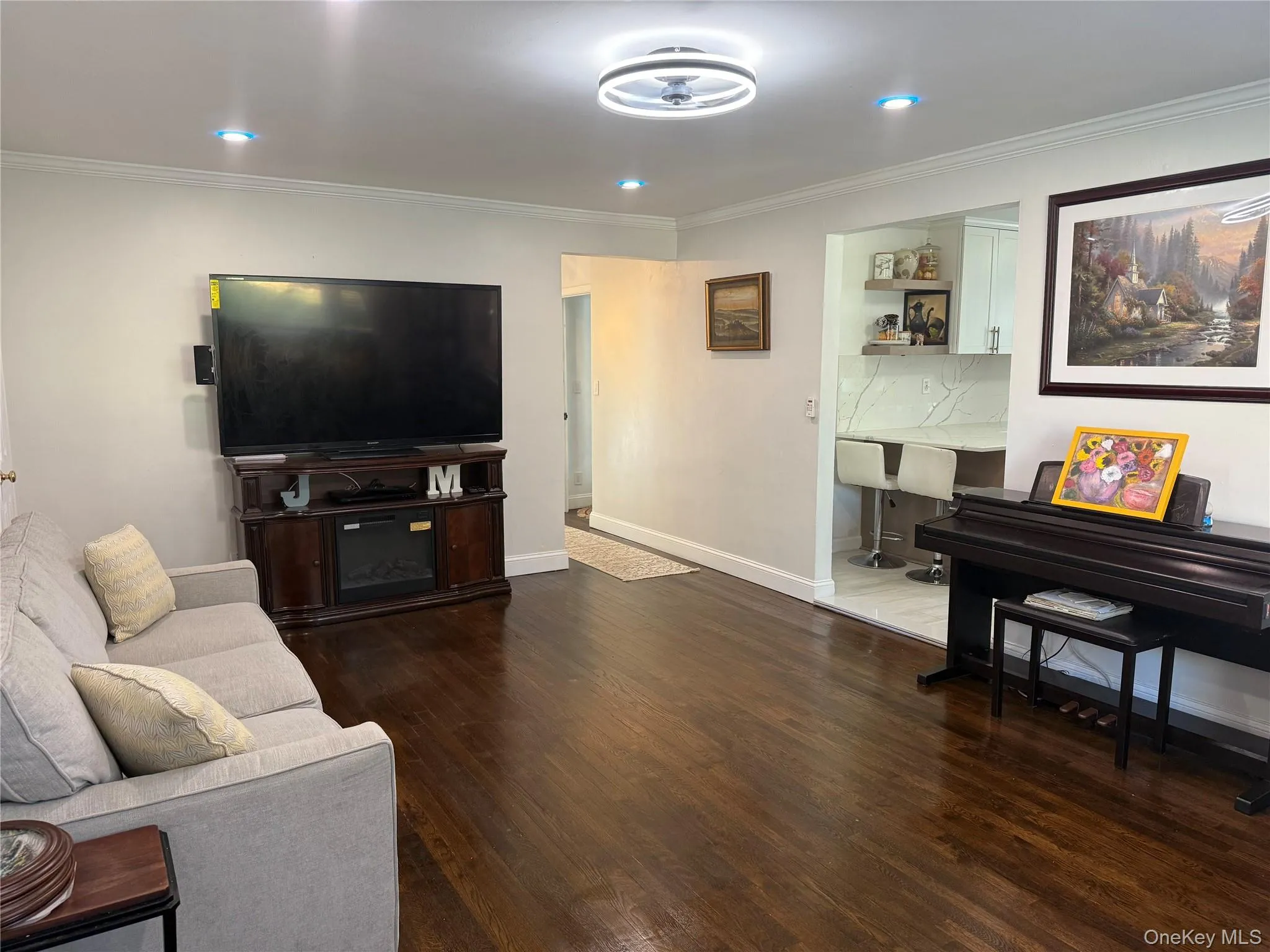 Living room wood flooring, crown molding and recessed lighting Living room wood flooring, crown molding and recessed lighting