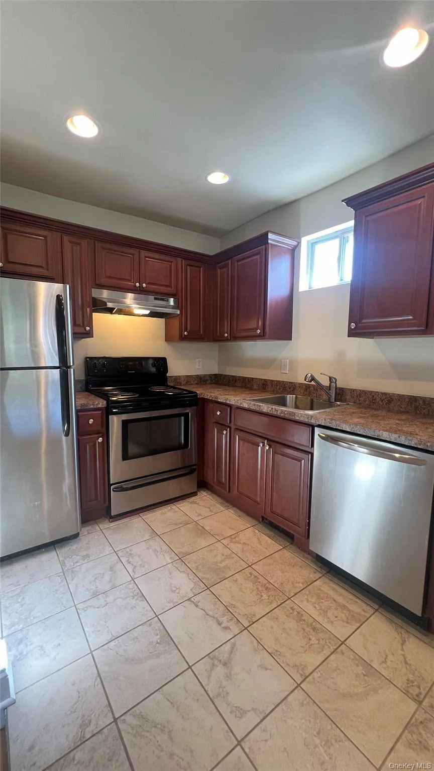 Kitchen with stainless steel appliances, recessed lighting, under cabinet range hood, and granite counters Kitchen with stainless steel appliances, recessed lighting, under cabinet range hood, and granite counters