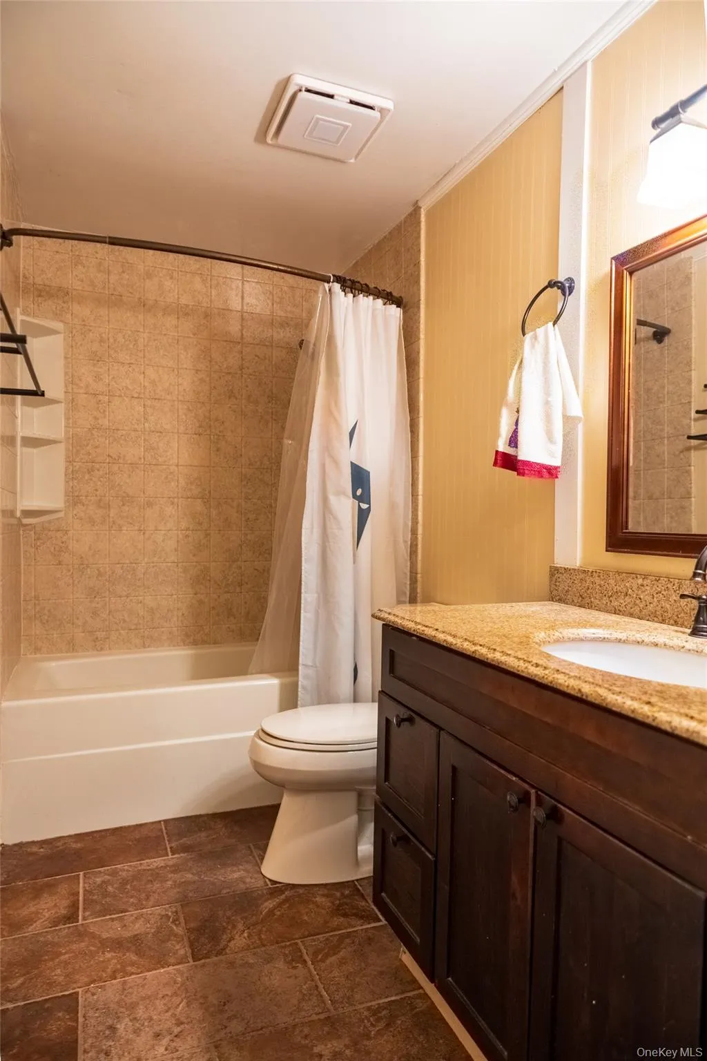 Bathroom featuring shower / bath combination with curtain and vanity Bathroom featuring shower / bath combination with curtain and vanity
