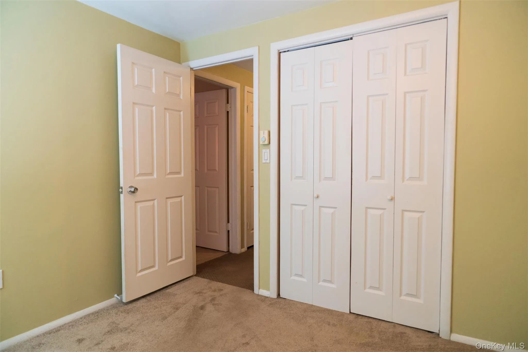 Unfurnished bedroom featuring carpet flooring and a closet Unfurnished bedroom featuring carpet flooring and a closet