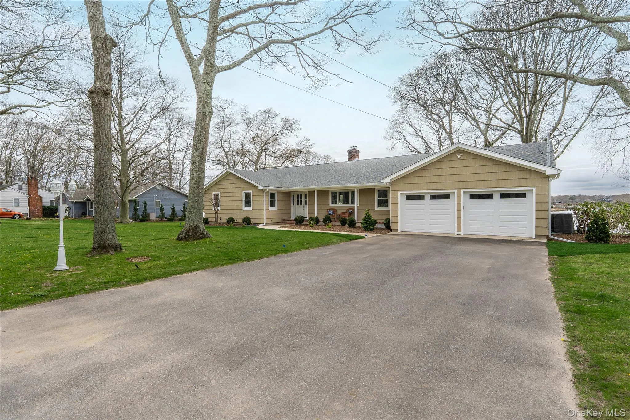 Ranch-style house featuring driveway, a chimney, a shingled roof, a front yard, and an attached garage Ranch-style house featuring driveway, a chimney, a shingled roof, a front yard, and an attached garage
