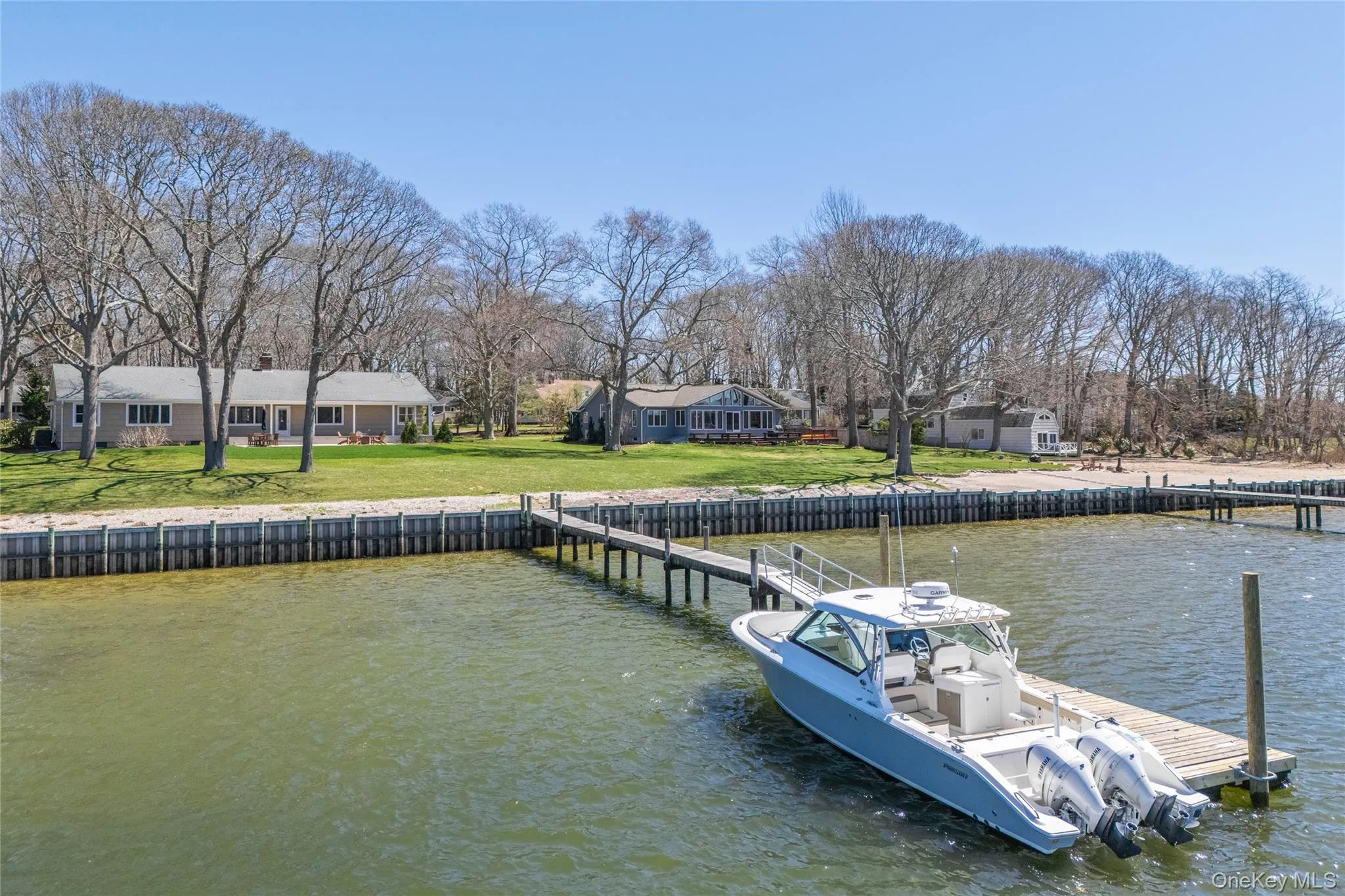 Dock area with a water view and a lawn Dock area with a water view and a lawn