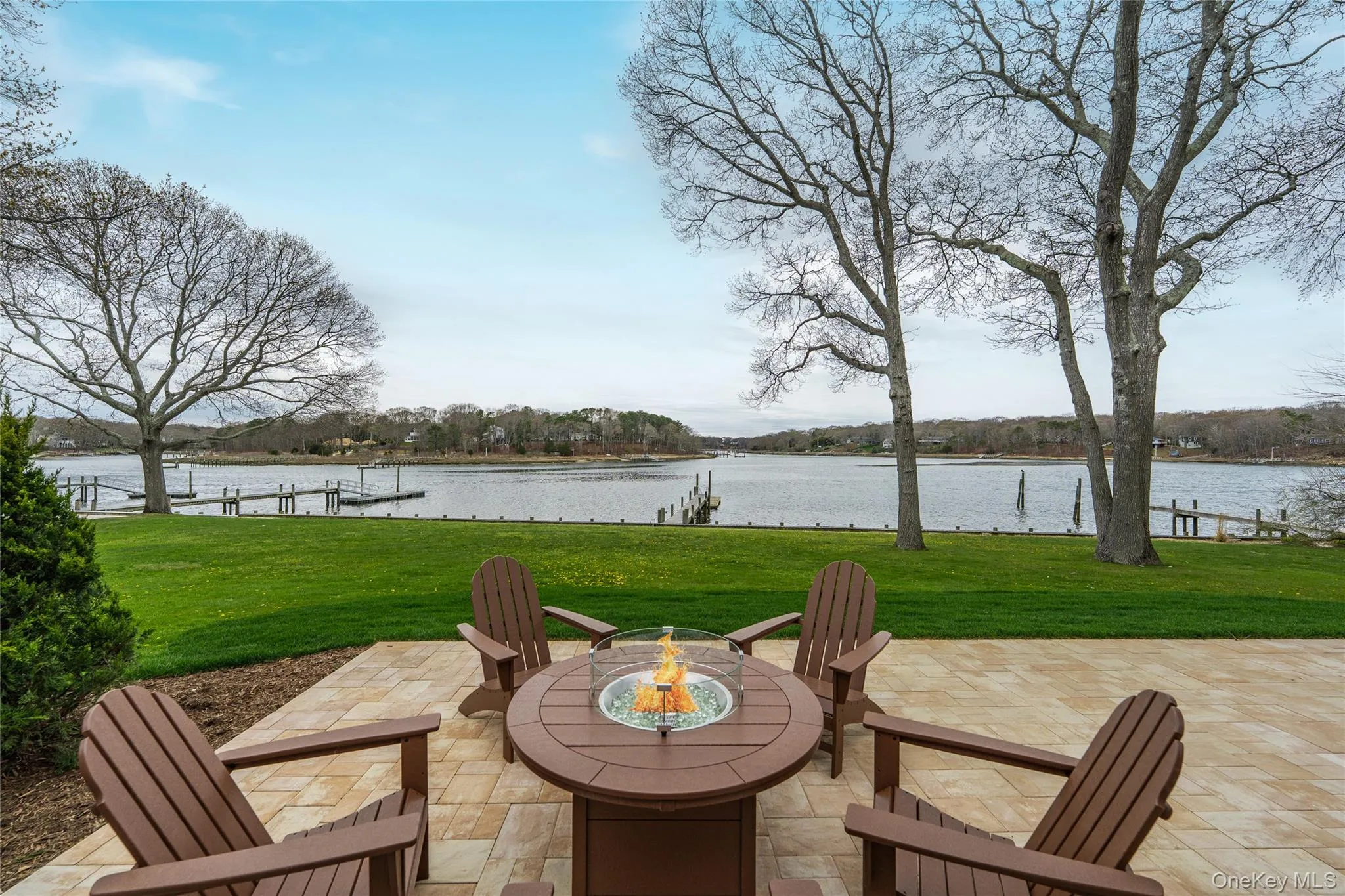 View of patio / terrace featuring a water view and a fire pit View of patio / terrace featuring a water view and a fire pit