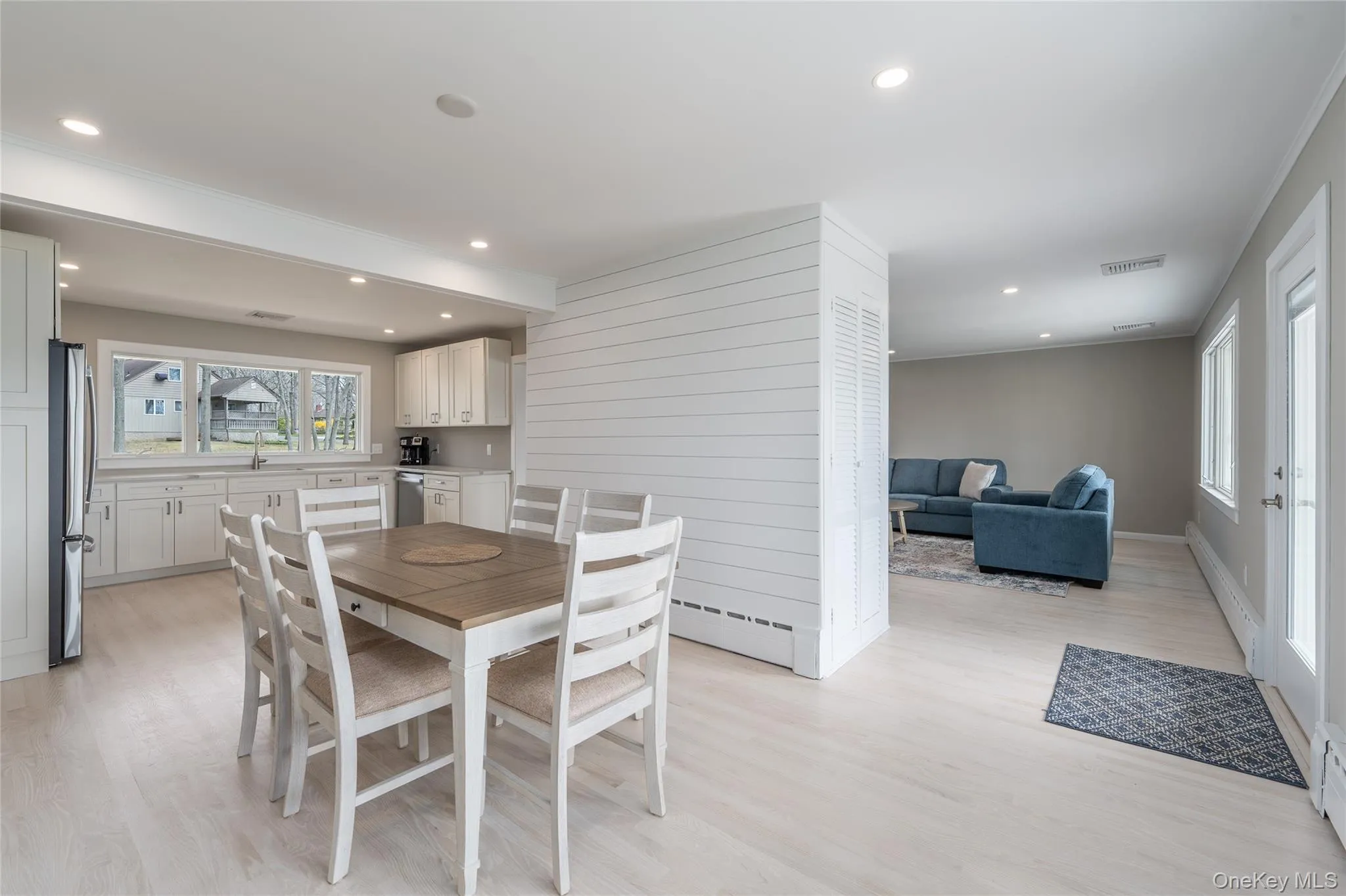 Dining space with recessed lighting, light wood-style floors, and a baseboard radiator Dining space with recessed lighting, light wood-style floors, and a baseboard radiator