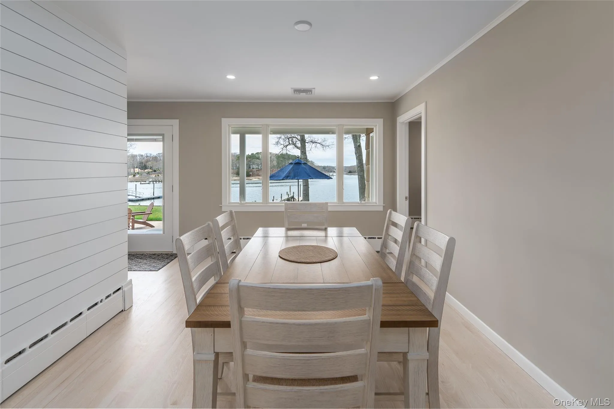 Dining room featuring visible vents, crown molding, light wood finished floors, and a baseboard radiator Dining room featuring visible vents, crown molding, light wood finished floors, and a baseboard radiator