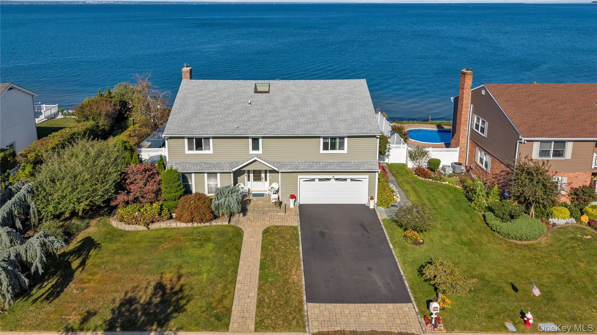 Drone / aerial view of a nearby body of water and a pool Drone / aerial view of a nearby body of water and a pool
