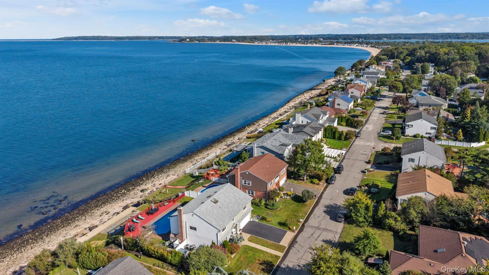 Aerial overview of property's location with nearby suburban area and unending shoreline Aerial overview of property's location with nearby suburban area and unending shoreline