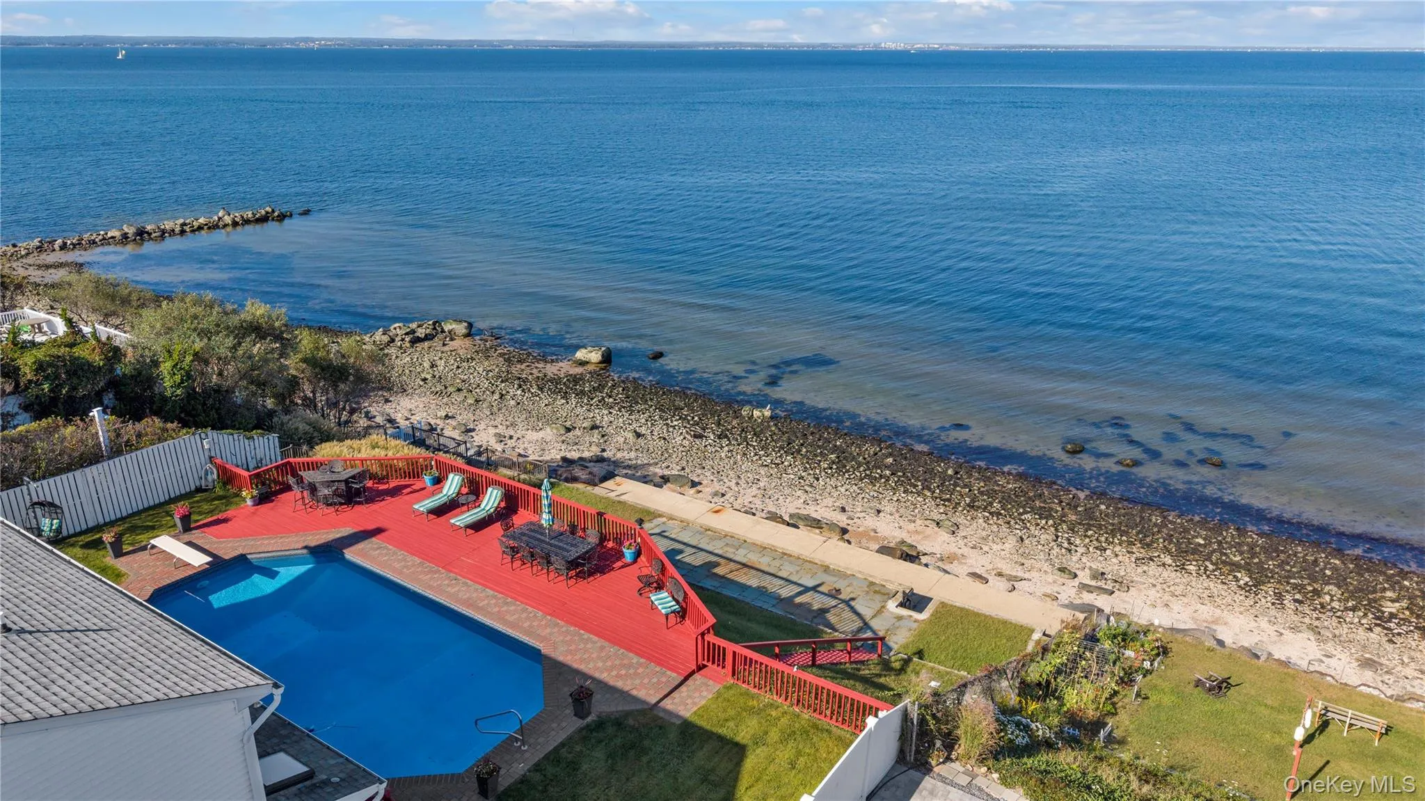 Bird's eye view of extended coastline and a pool Bird's eye view of extended coastline and a pool
