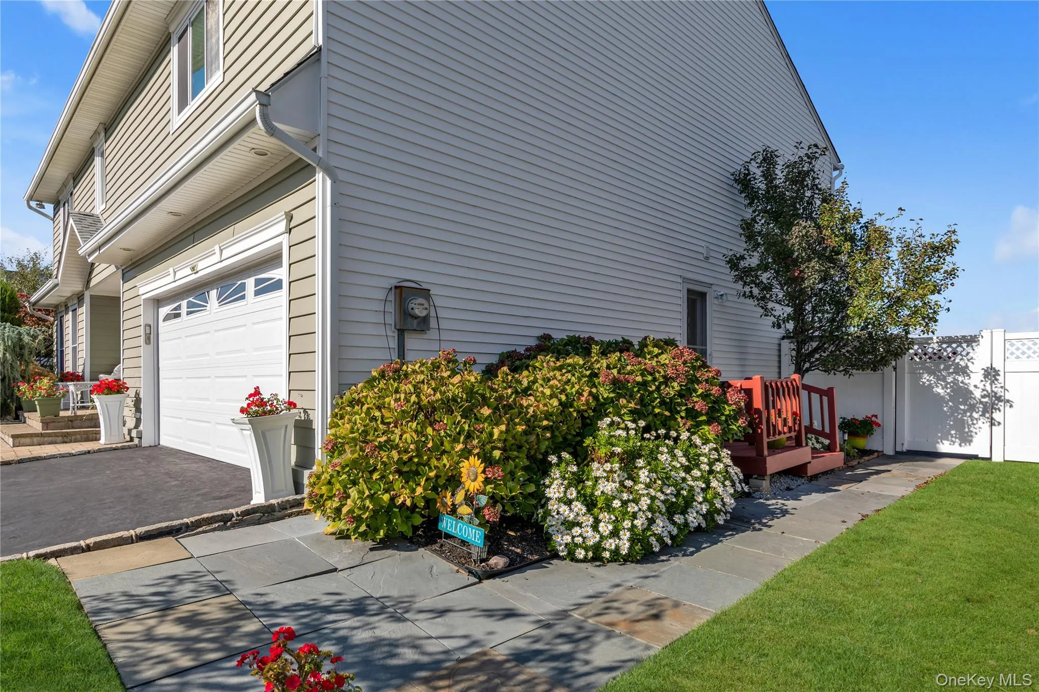 View of side of home featuring an attached garage and driveway View of side of home featuring an attached garage and driveway