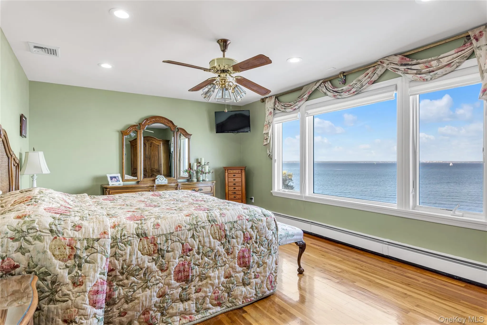 Bedroom featuring a baseboard radiator, light wood-style floors, recessed lighting, and ceiling fan Bedroom featuring a baseboard radiator, light wood-style floors, recessed lighting, and ceiling fan