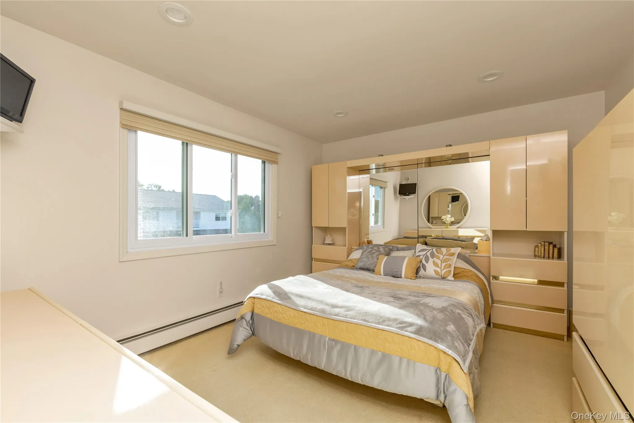 Bedroom featuring baseboard heating, light colored carpet, and recessed lighting Bedroom featuring baseboard heating, light colored carpet, and recessed lighting