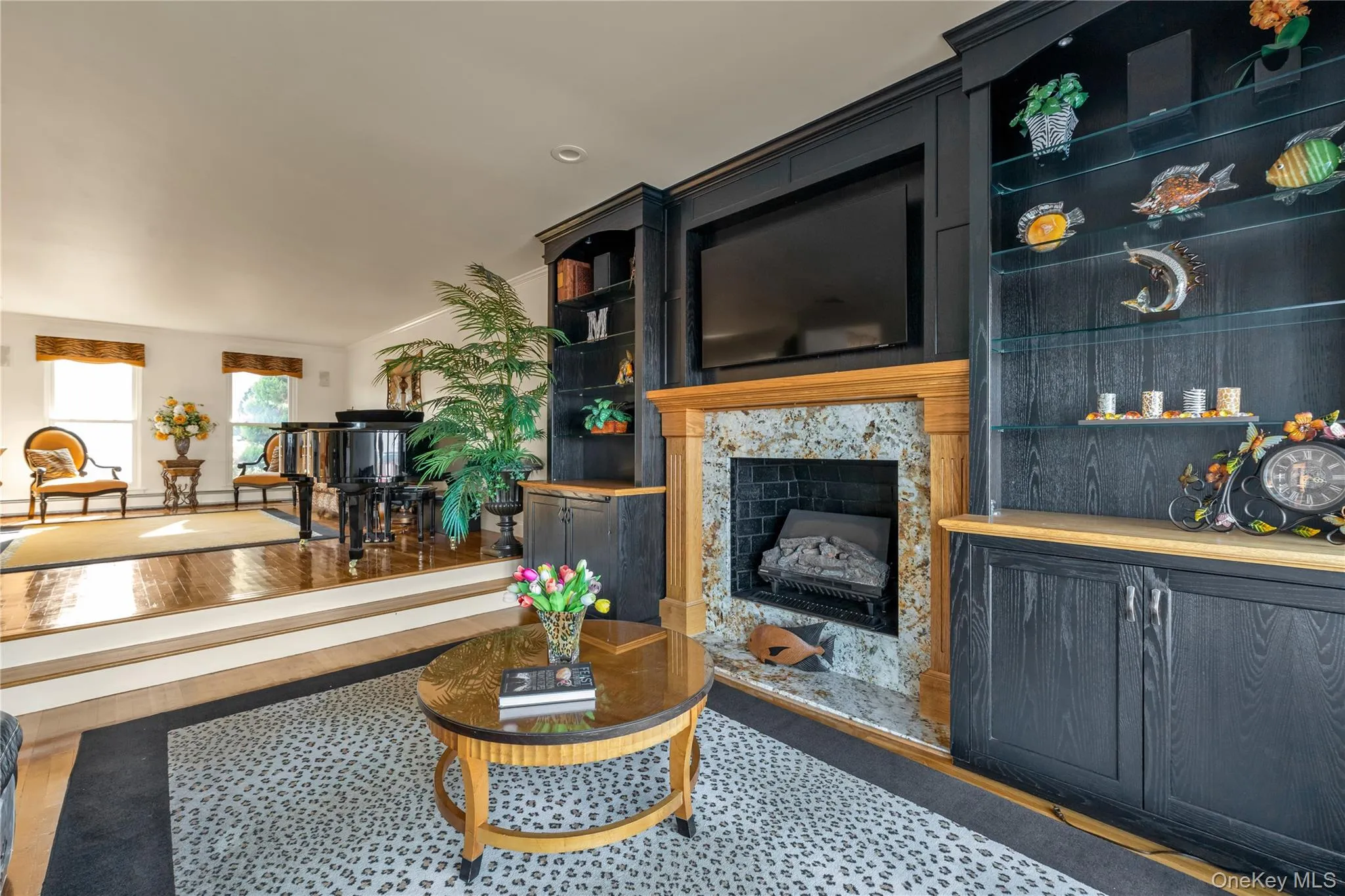 Living room featuring a fireplace and wood finished floors Living room featuring a fireplace and wood finished floors