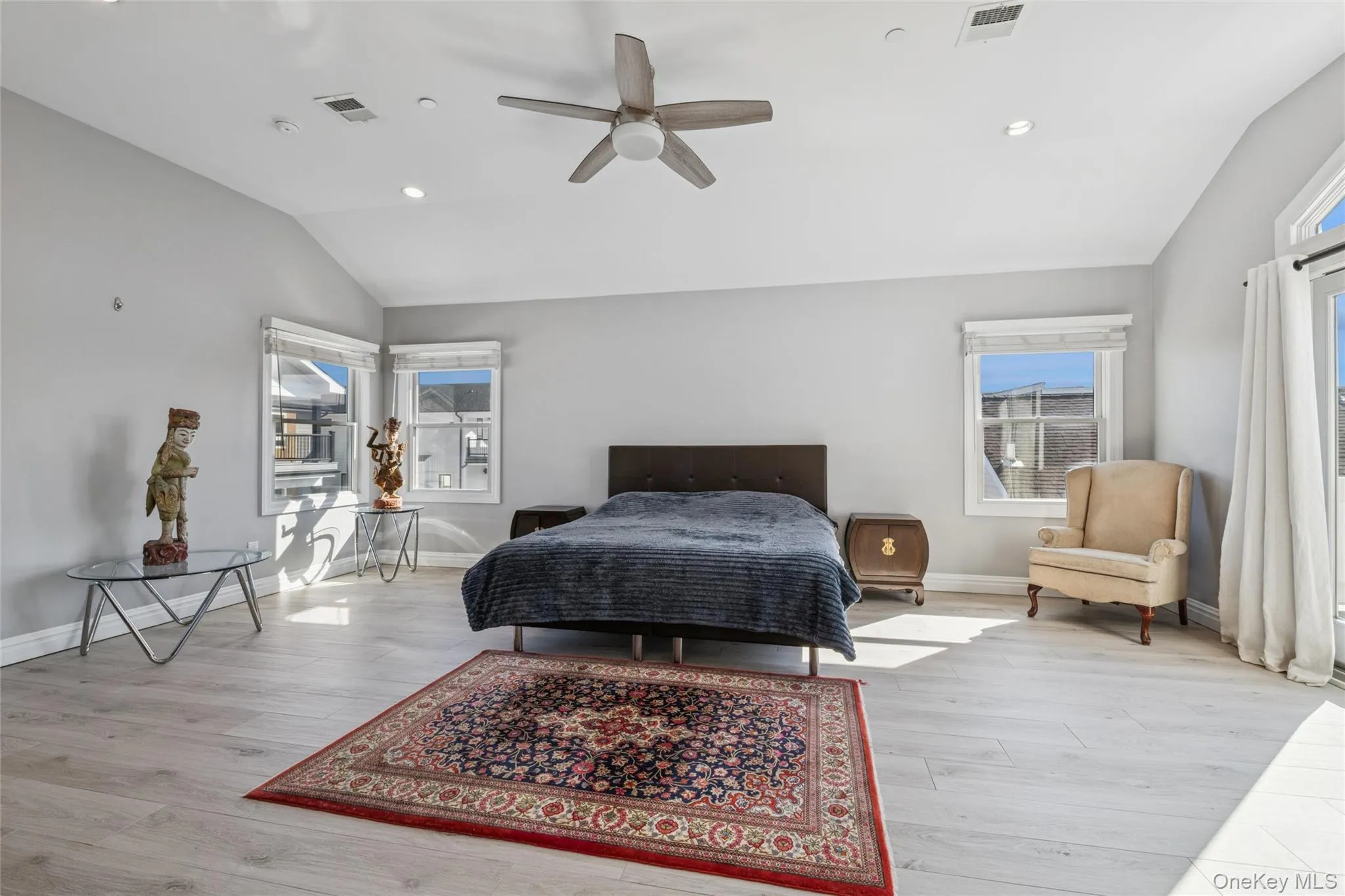 Bedroom with lofted ceiling, ceiling fan, light wood-style flooring, and recessed lighting Bedroom with lofted ceiling, ceiling fan, light wood-style flooring, and recessed lighting