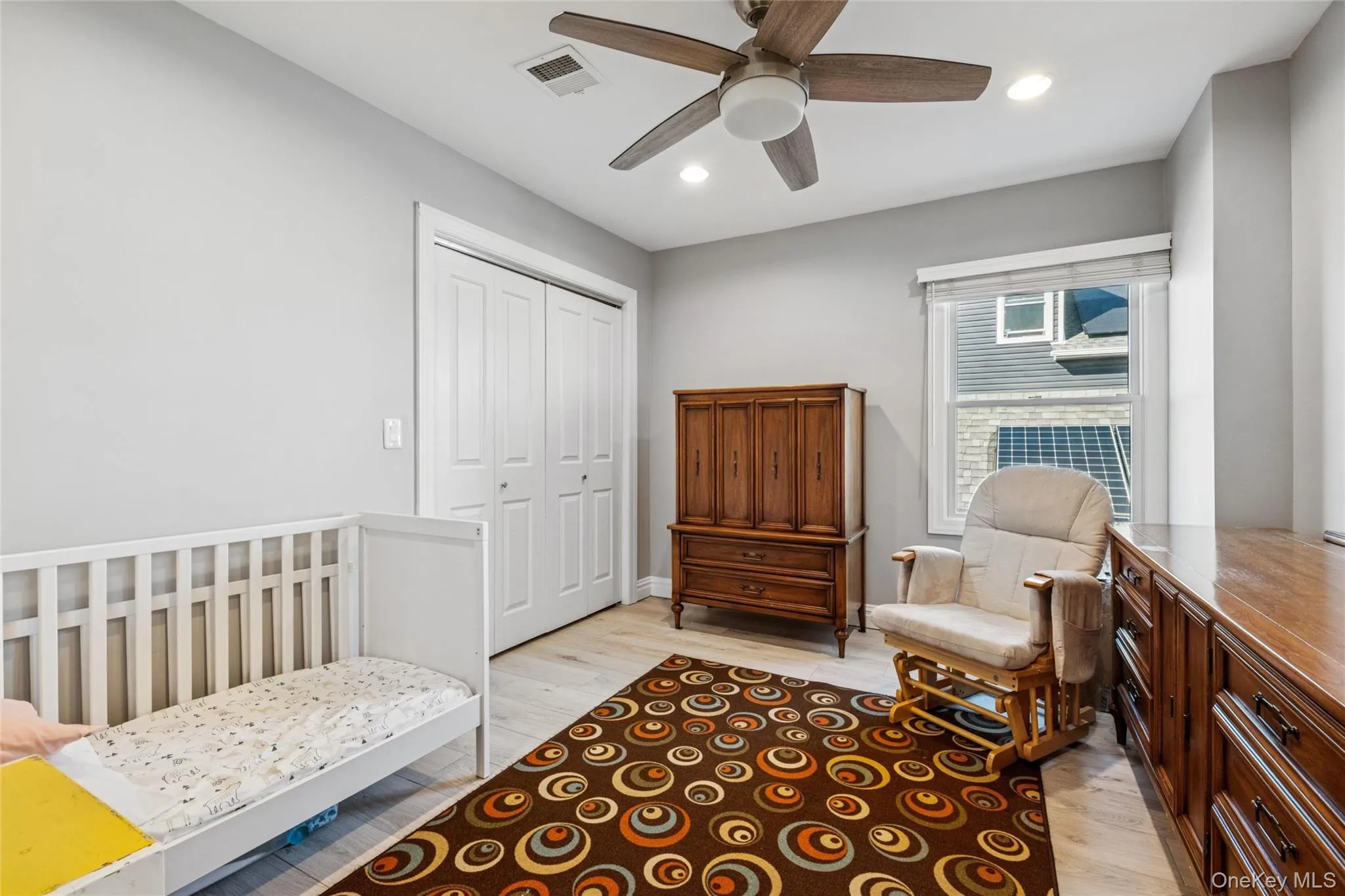 Bedroom featuring recessed lighting, a closet, a ceiling fan, and light wood finished floors Bedroom featuring recessed lighting, a closet, a ceiling fan, and light wood finished floors
