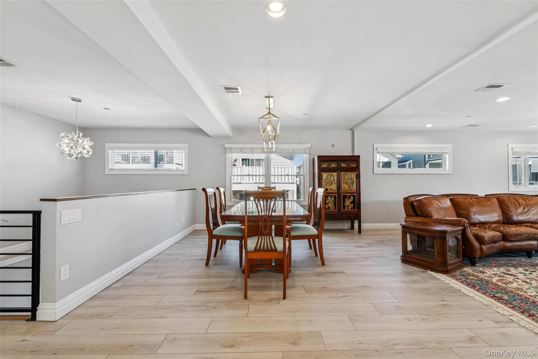 Dining room with a chandelier, light wood-style flooring, recessed lighting, and beamed ceiling Dining room with a chandelier, light wood-style flooring, recessed lighting, and beamed ceiling