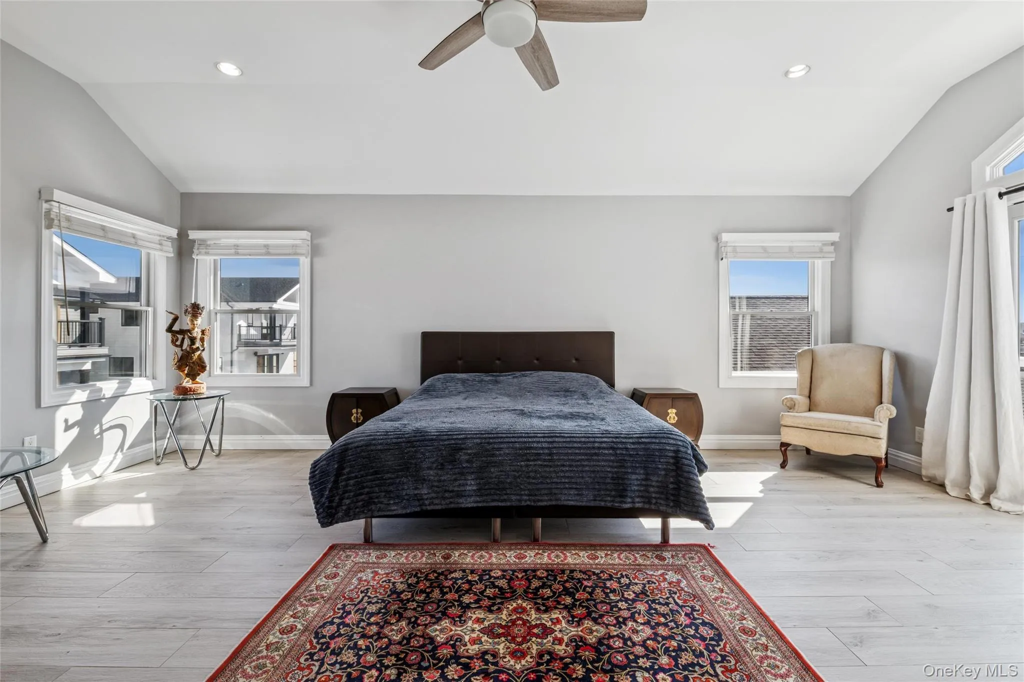 Bedroom featuring vaulted ceiling, recessed lighting, a ceiling fan, and light wood-style floors Bedroom featuring vaulted ceiling, recessed lighting, a ceiling fan, and light wood-style floors