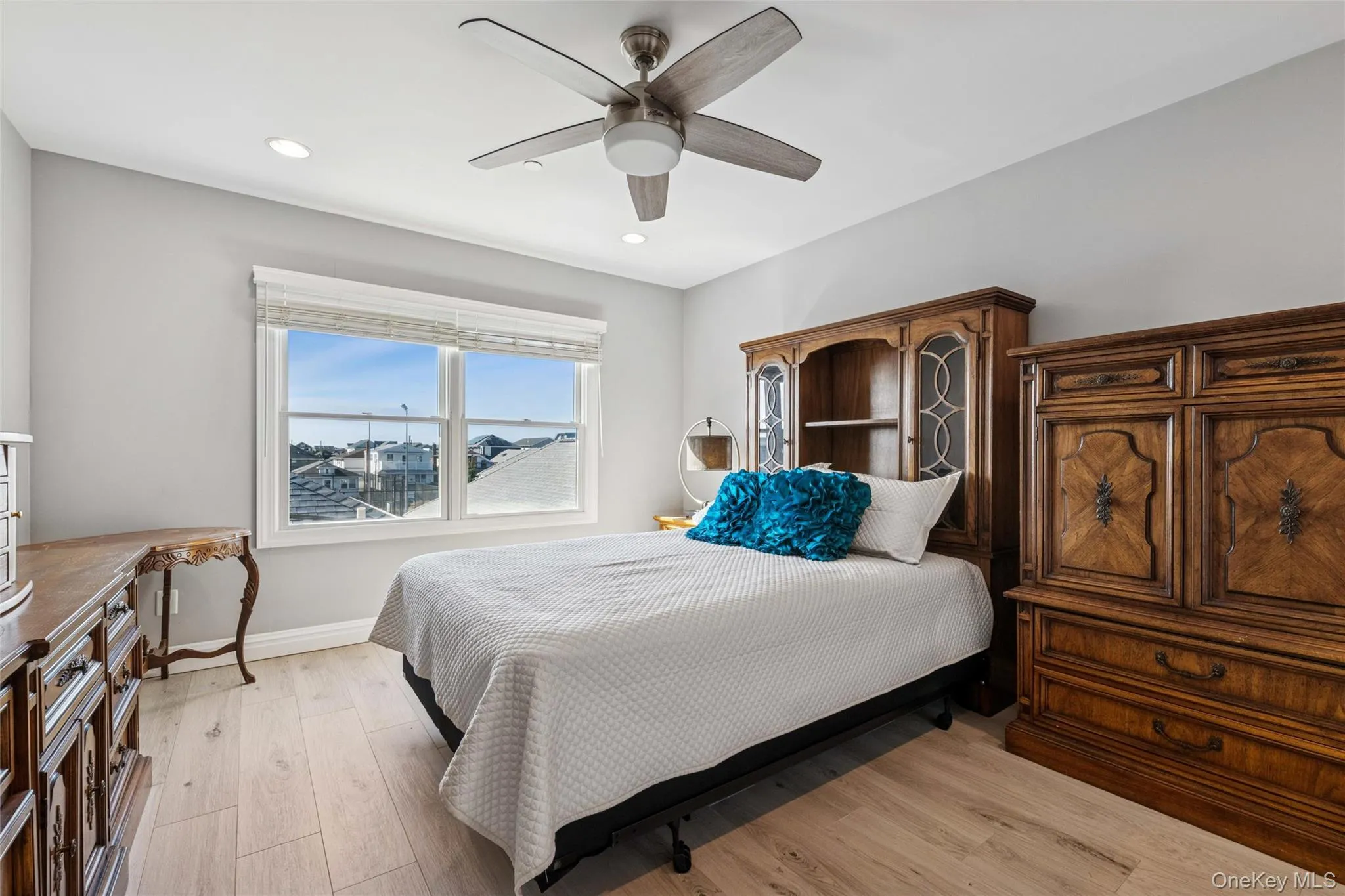 Bedroom featuring light wood-style flooring, ceiling fan, and recessed lighting Bedroom featuring light wood-style flooring, ceiling fan, and recessed lighting