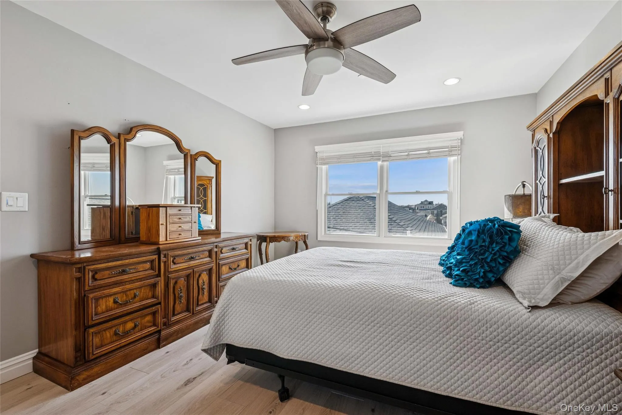 Bedroom featuring light wood-style floors, a ceiling fan, and recessed lighting Bedroom featuring light wood-style floors, a ceiling fan, and recessed lighting