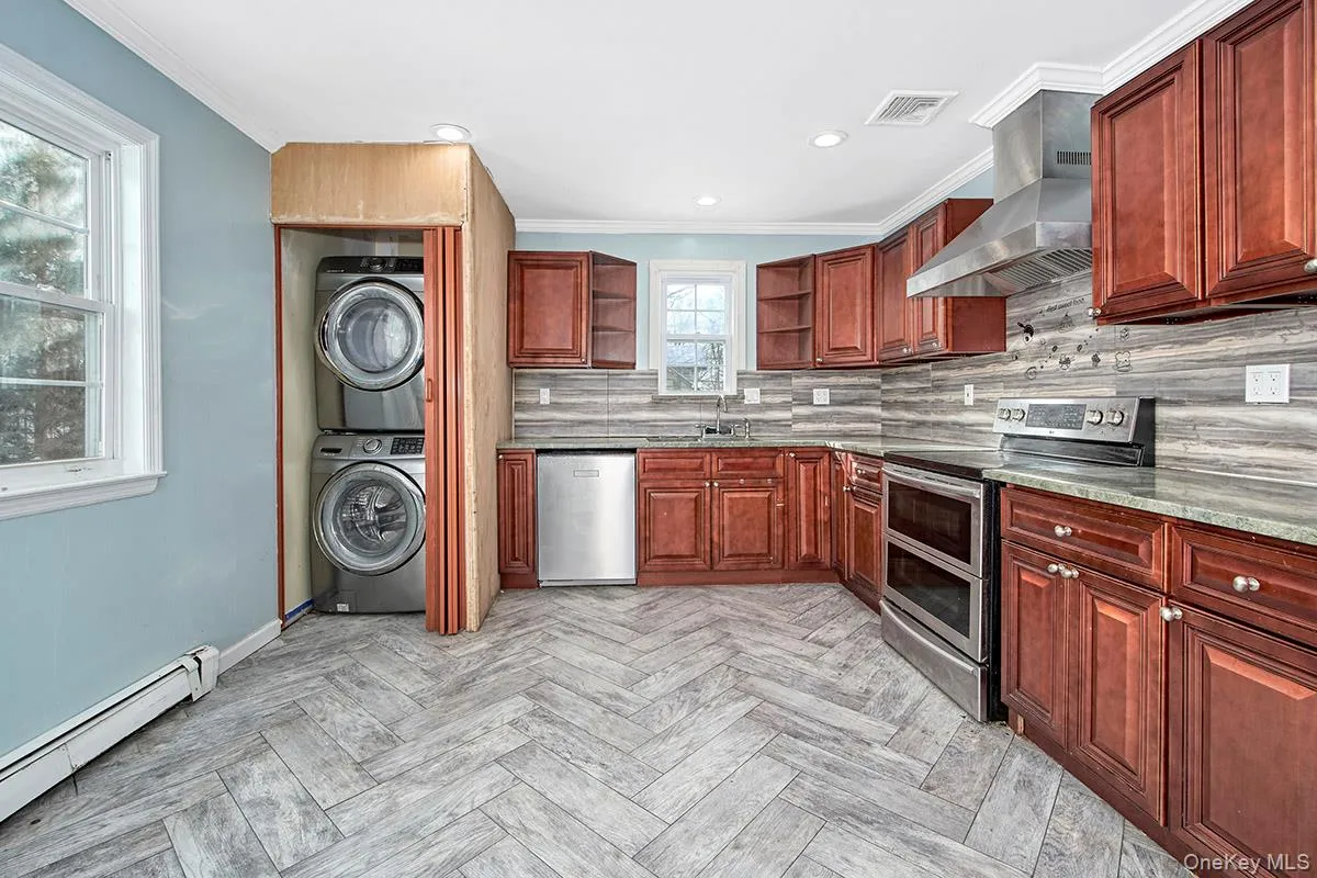 Eat-in kitchen with stainless steel appliances. Washer and dryer in unit. Eat-in kitchen with stainless steel appliances. Washer and dryer in unit.