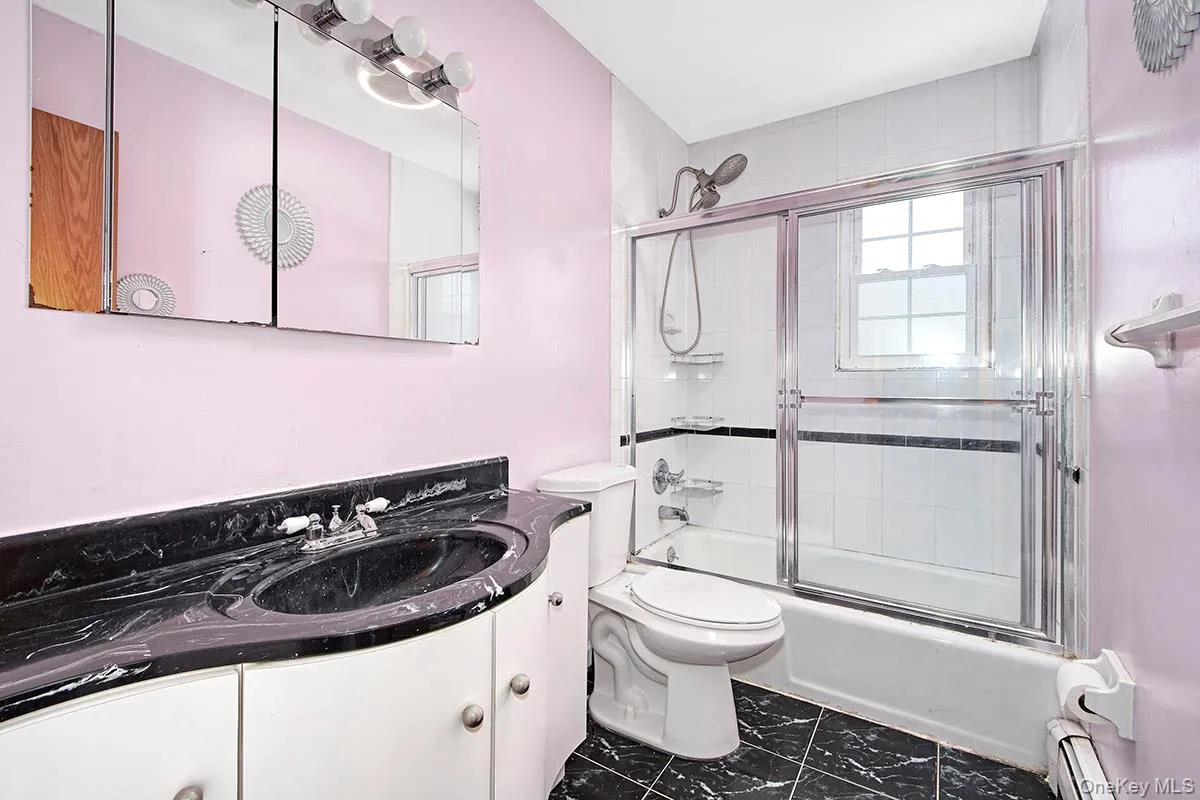 Full bathroom with pretty vanity and shower/bath combo Full bathroom with pretty vanity and shower/bath combo