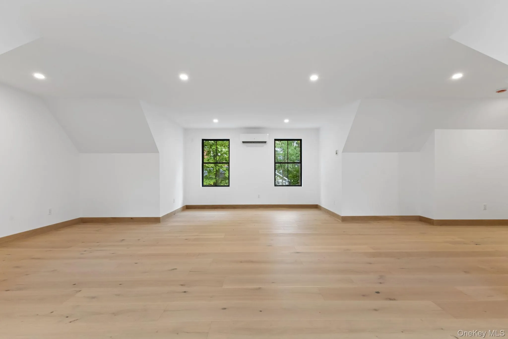 Additional living space featuring recessed lighting, light wood finished floors, and lofted ceiling Additional living space featuring recessed lighting, light wood finished floors, and lofted ceiling
