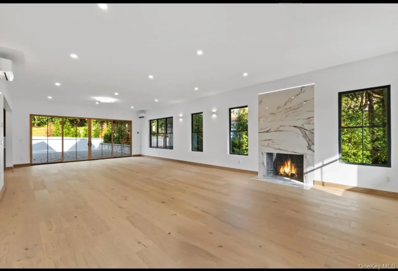 Unfurnished living room/dining room with a fireplace, light wood-type flooring Unfurnished living room/dining room with a fireplace, light wood-type flooring