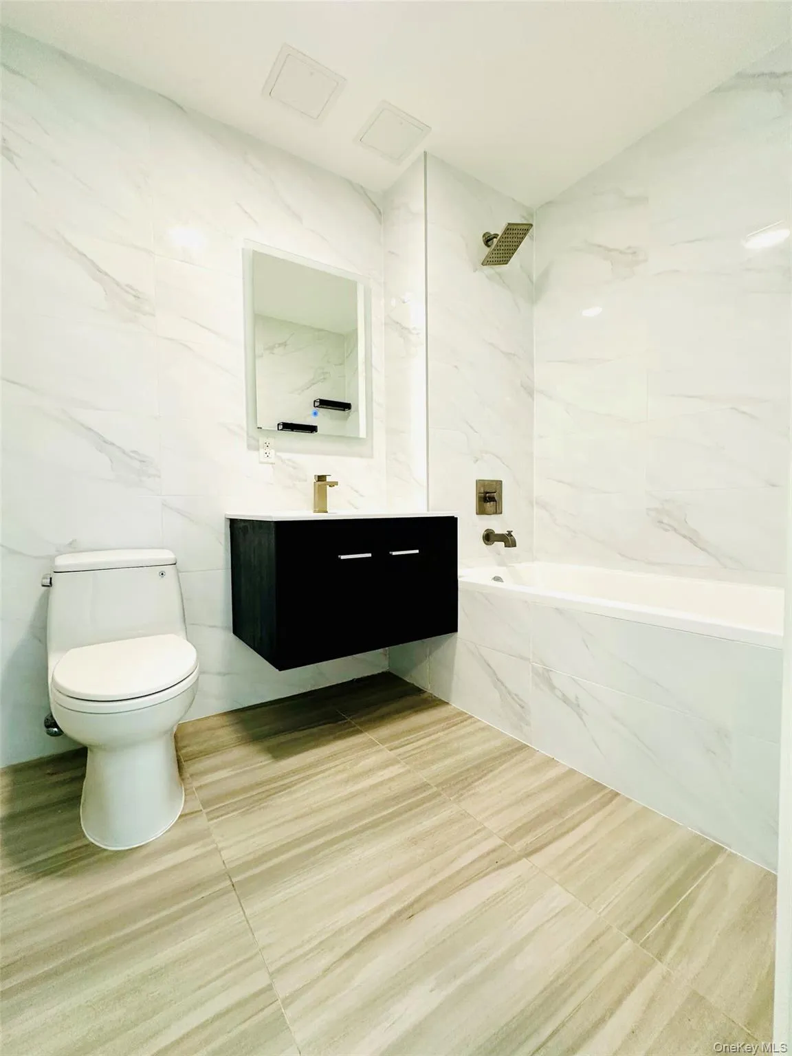 Bathroom with tile walls, a combined bath / shower with marble appearance, vanity, and tile patterned floors Bathroom with tile walls, a combined bath / shower with marble appearance, vanity, and tile patterned floors
