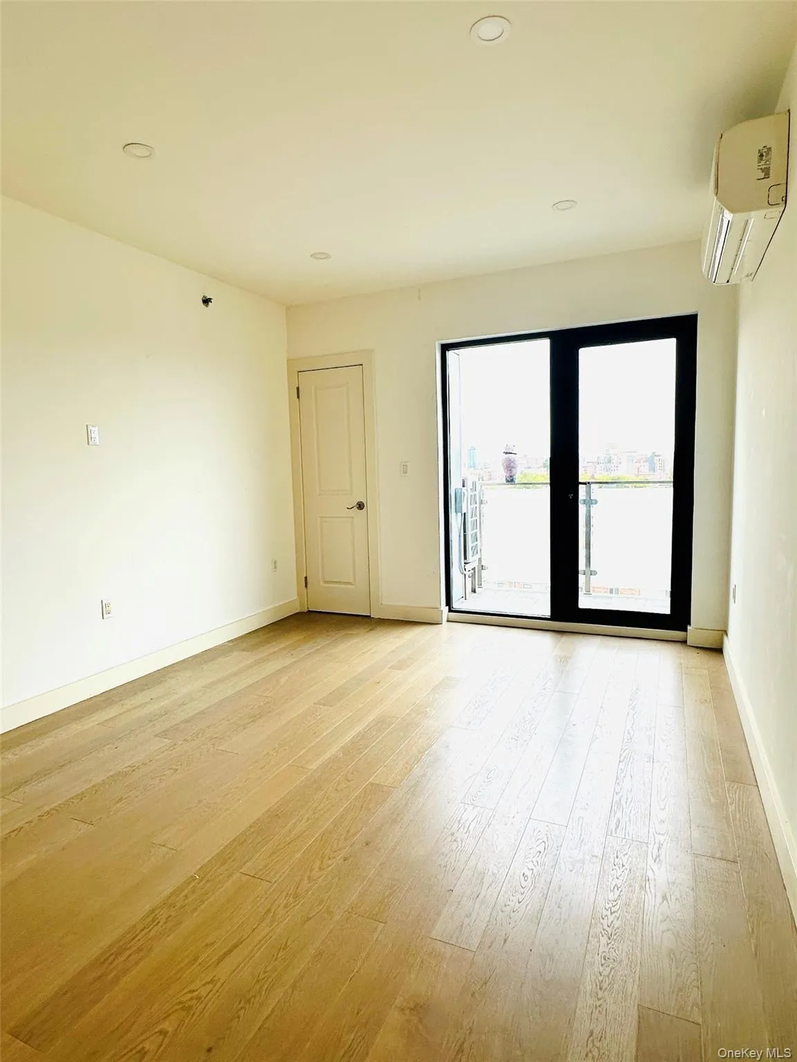 Spare room featuring recessed lighting, light wood finished floors, and a wall unit AC Spare room featuring recessed lighting, light wood finished floors, and a wall unit AC