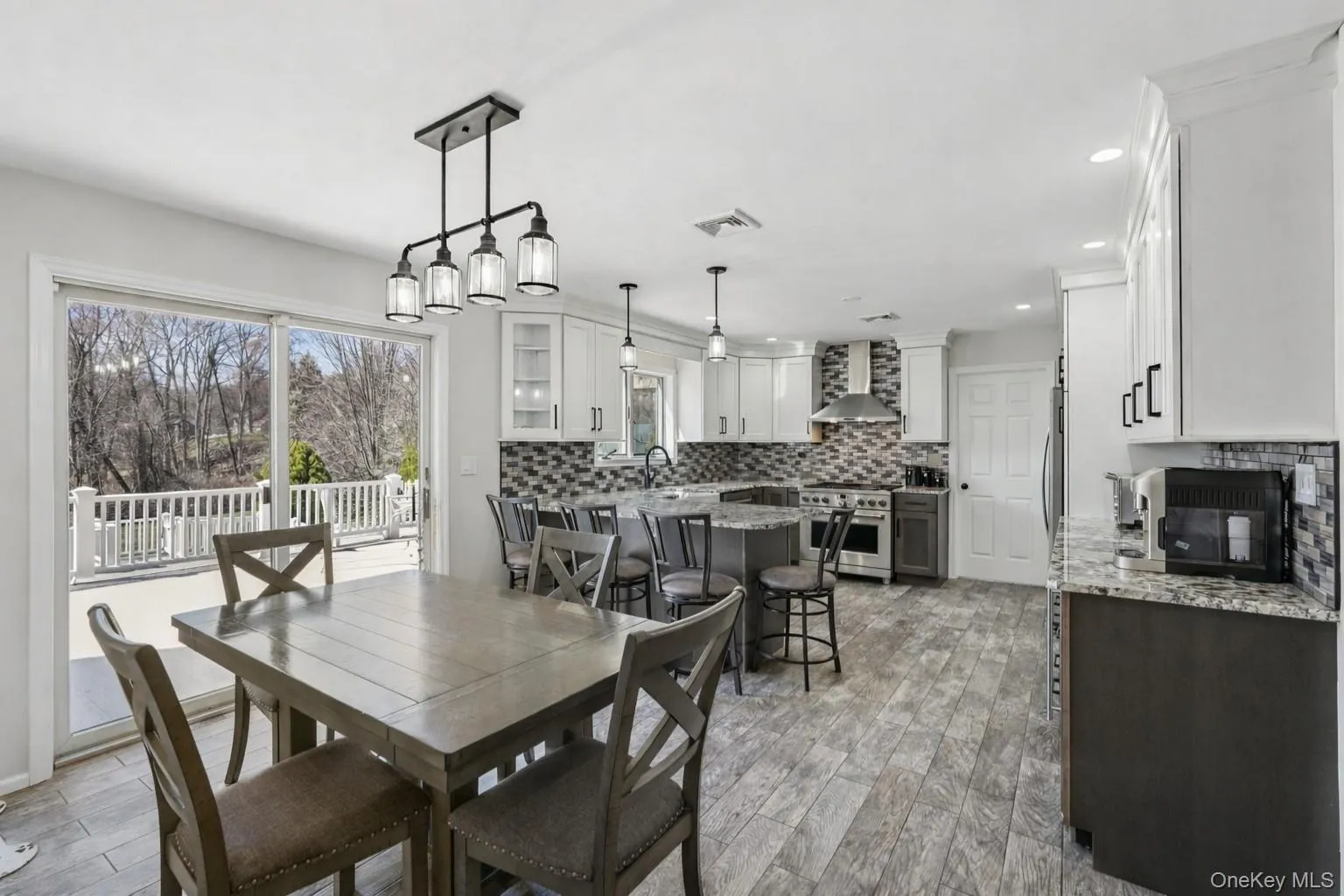 Eat-in kitchen with granite counters and sliding glass doors leading to outside deck Eat-in kitchen with granite counters and sliding glass doors leading to outside deck