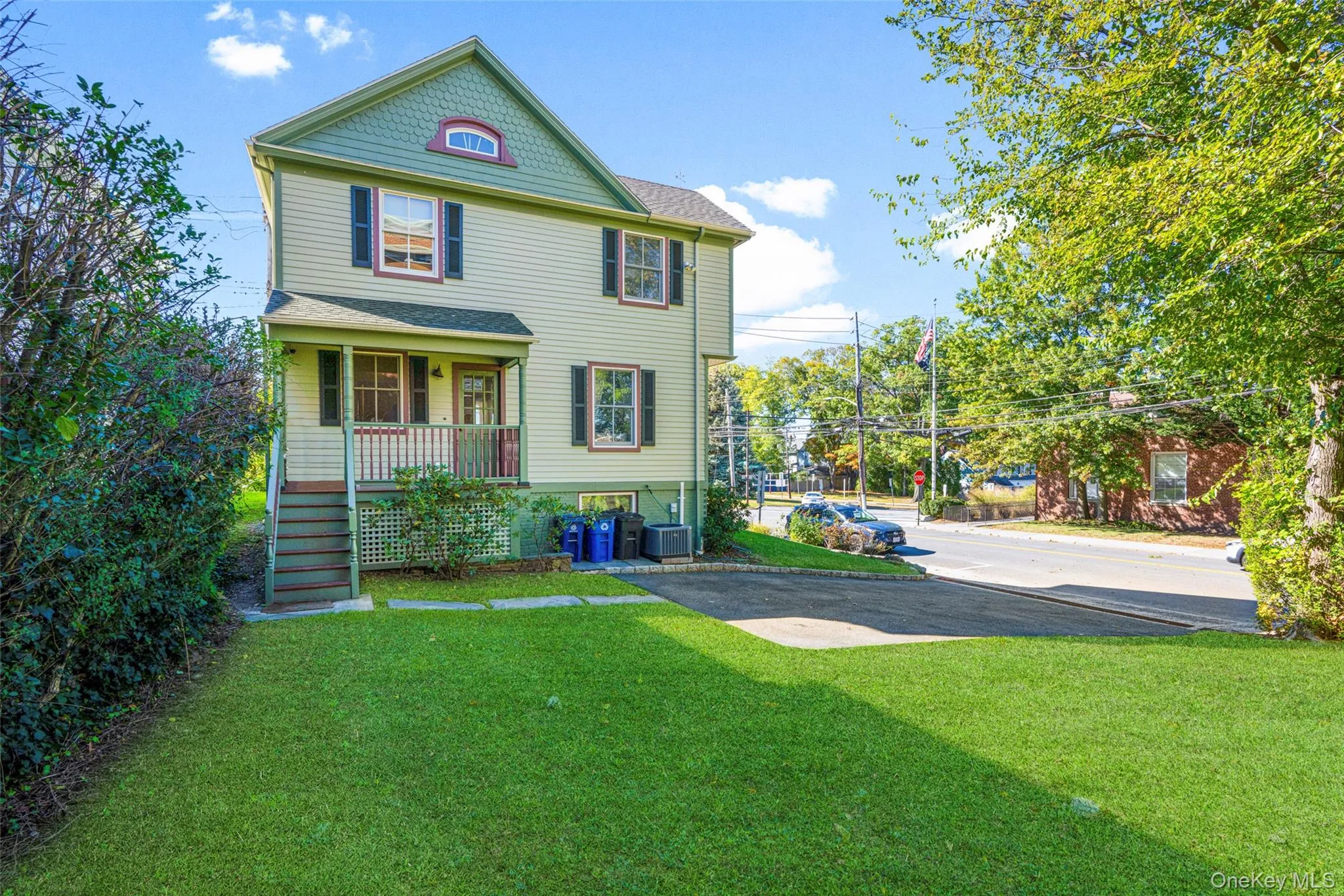 Victorian-style house featuring a backyard, covered back porch and access to lower level entrance Victorian-style house featuring a backyard, covered back porch and access to lower level entrance