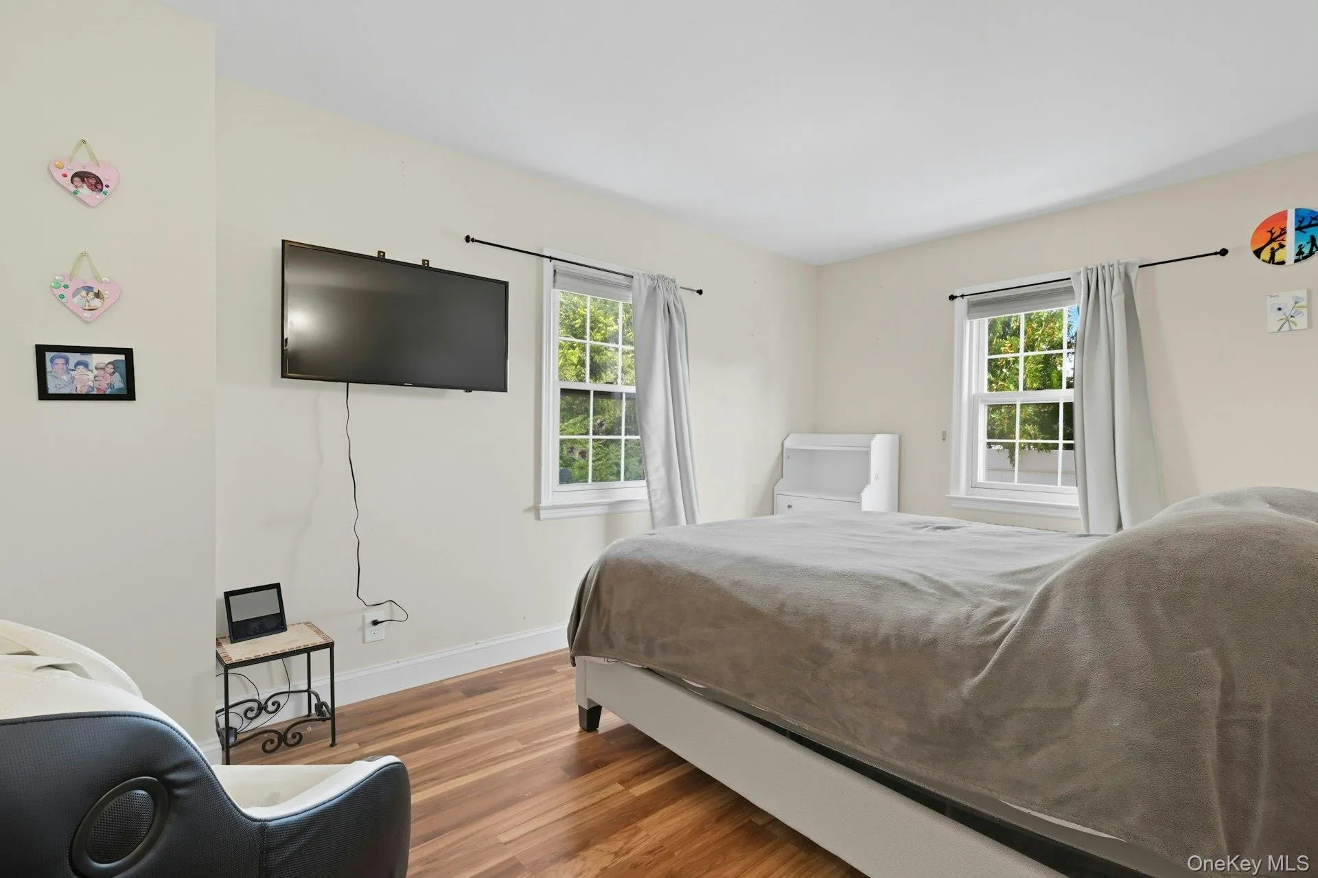 Bedroom with wood finished floors and baseboards Bedroom with wood finished floors and baseboards