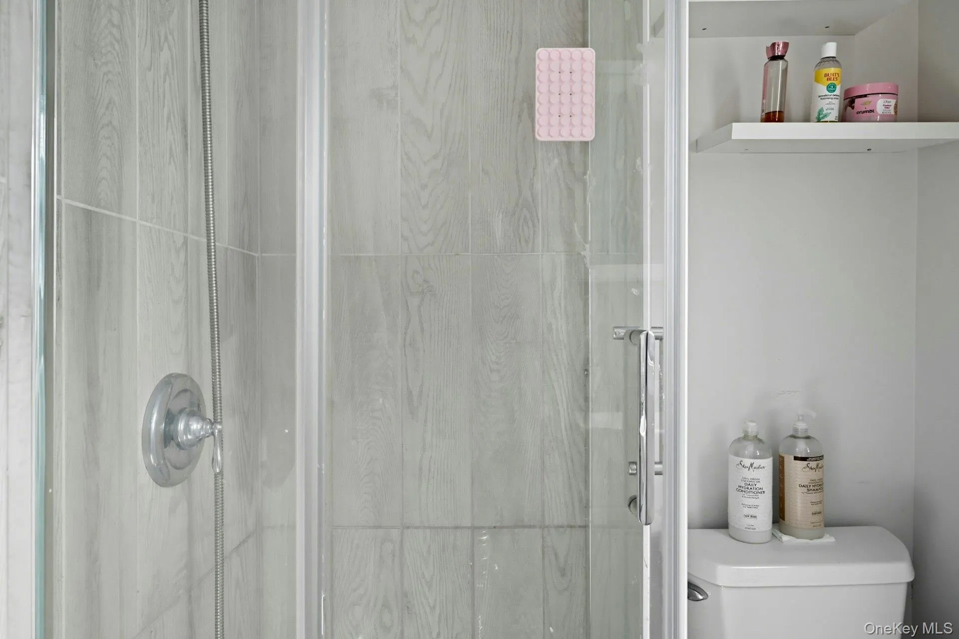 Full bath featuring a shower stall and toilet Full bath featuring a shower stall and toilet