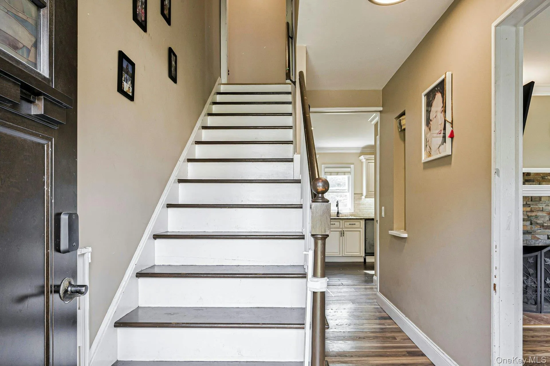 Staircase featuring wood finished floors and baseboards Staircase featuring wood finished floors and baseboards