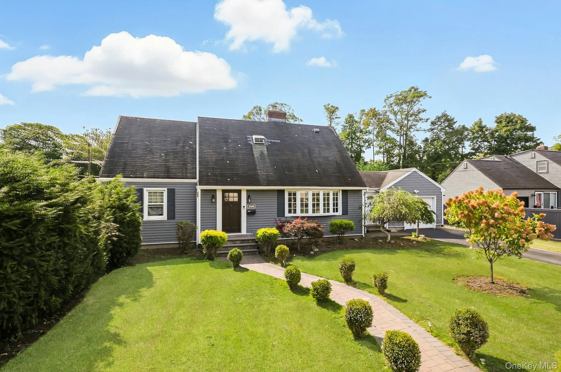 Rear view of house featuring a lawn, a chimney, and a shingled roof Rear view of house featuring a lawn, a chimney, and a shingled roof