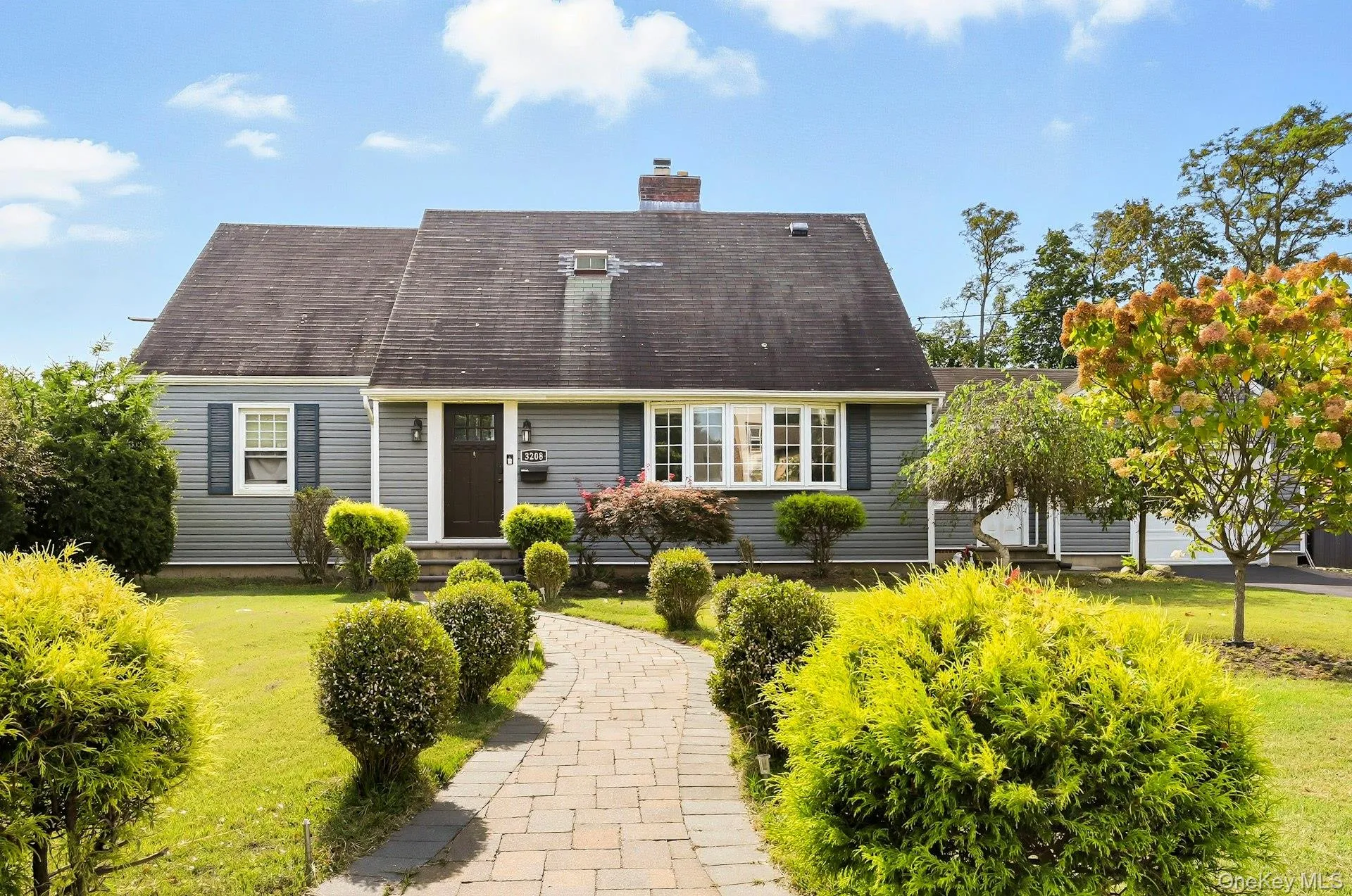 Cape cod house with a front lawn and a chimney Cape cod house with a front lawn and a chimney