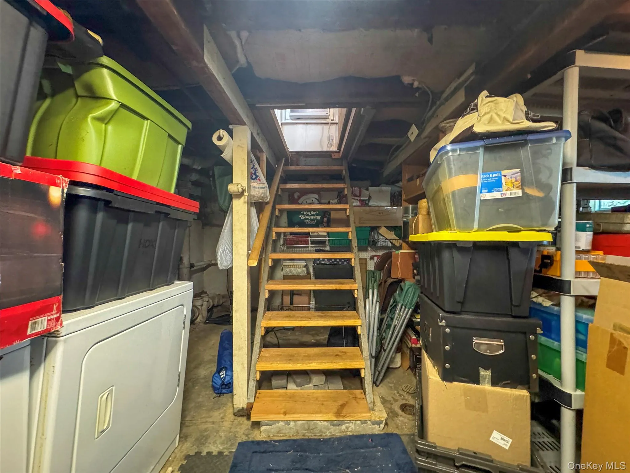 Storage room featuring washer / clothes dryer Storage room featuring washer / clothes dryer