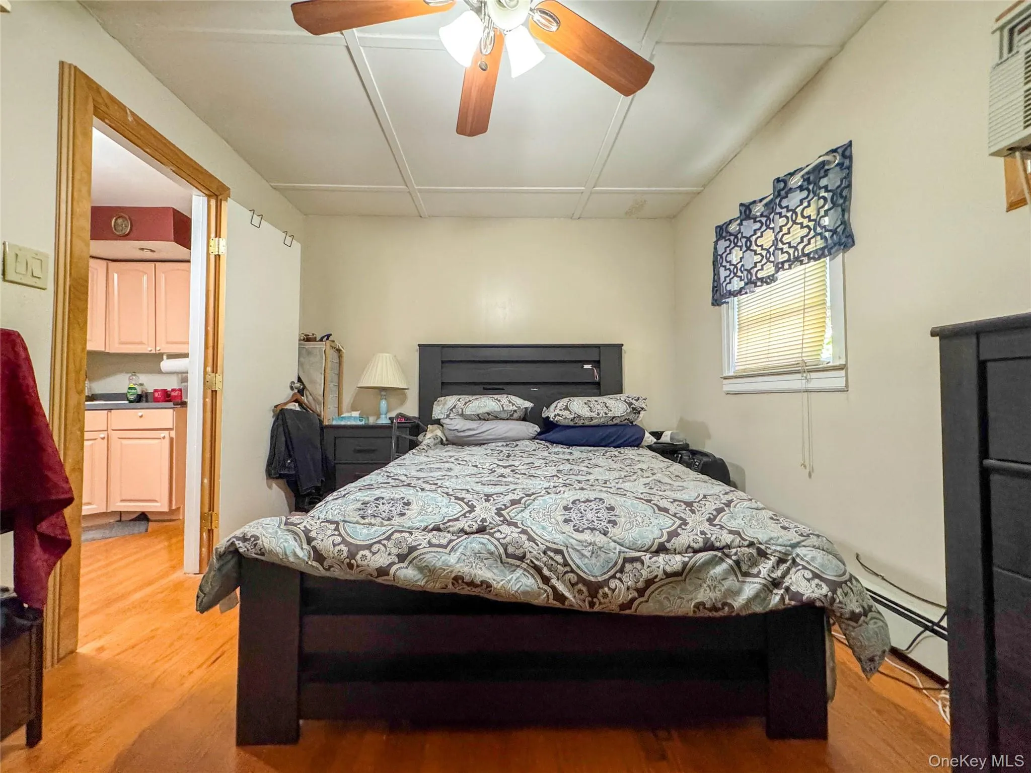 Bedroom with light wood-style floors and ceiling fan Bedroom with light wood-style floors and ceiling fan