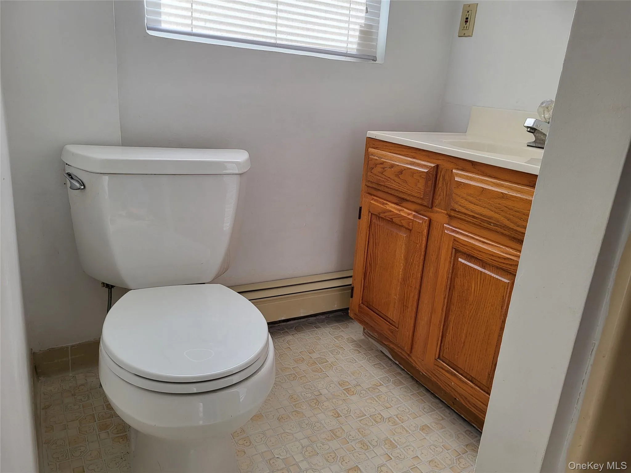 Bathroom with vanity and a baseboard radiator Bathroom with vanity and a baseboard radiator