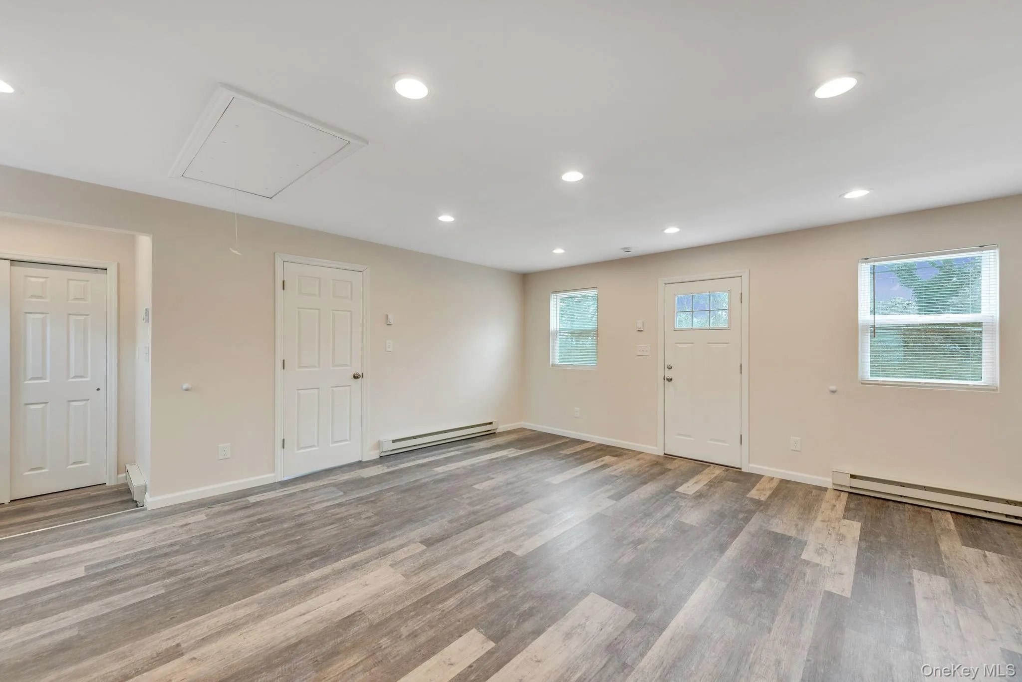Foyer entrance with recessed lighting, a baseboard radiator, and light wood-style floors Foyer entrance with recessed lighting, a baseboard radiator, and light wood-style floors