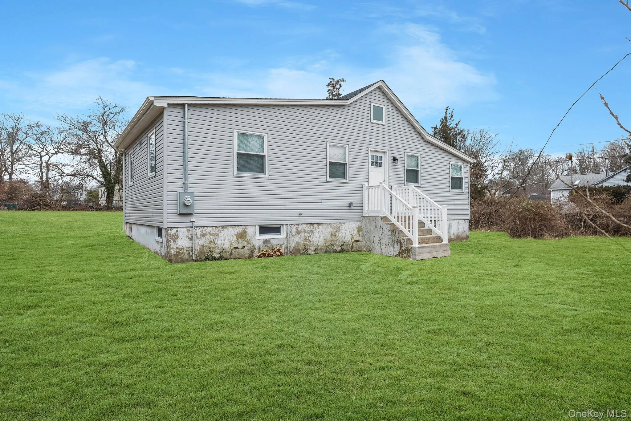 Back of property with a lawn Back of property with a lawn
